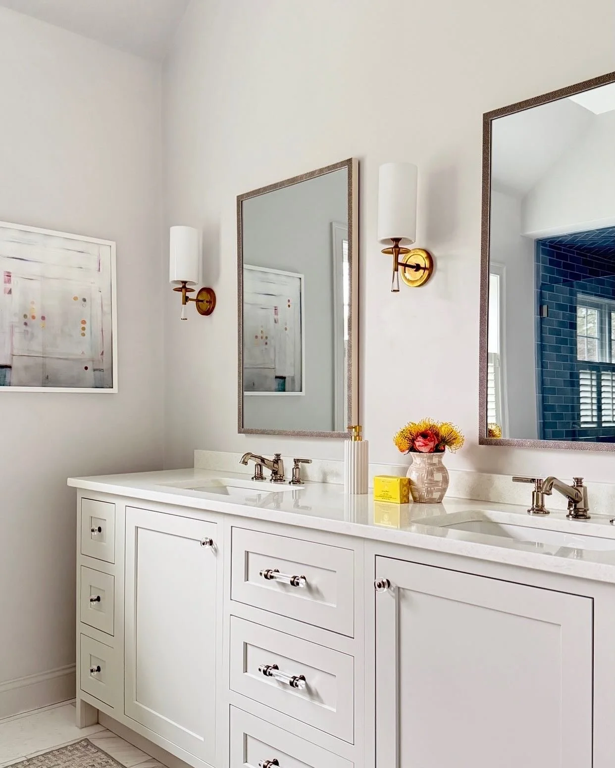 Our long-time clients were ready to renovate their primary bath and we were ready for it! Their priorities were a spa-like feel, a luxurious tub, and some pretty, blue tile in the shower. We brought our love of stone, mixed metals, custom mirrors, an