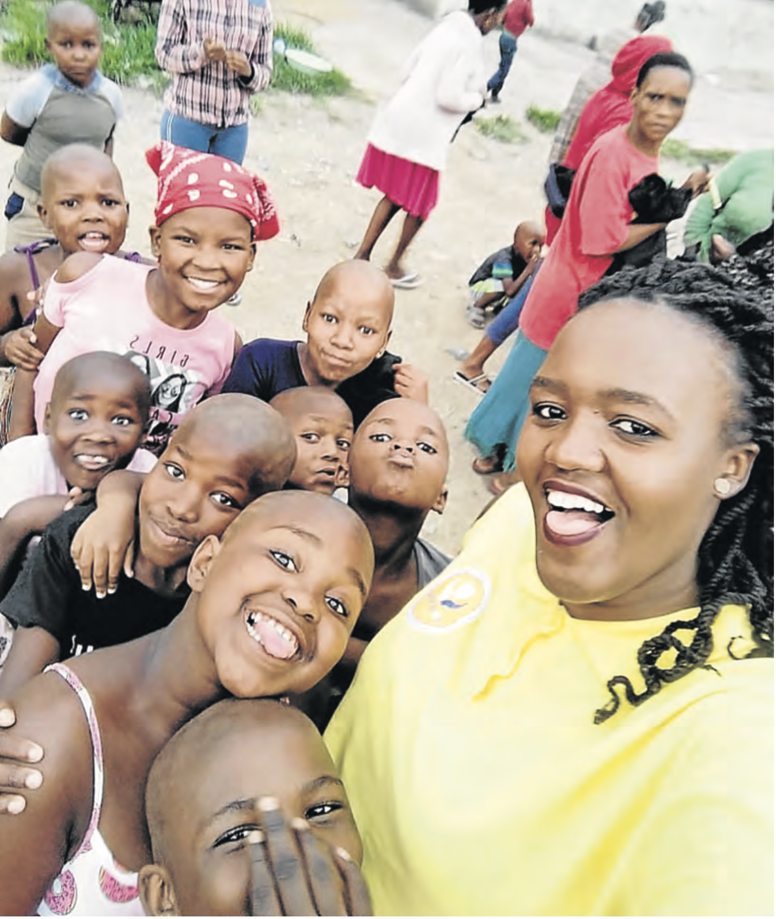 CARING: Noluvuyo Zintle Mehlomakhulu , dubbed Etipini ‘s Mother Teresa, with some of the children she assists. Picture: SUPPLIED