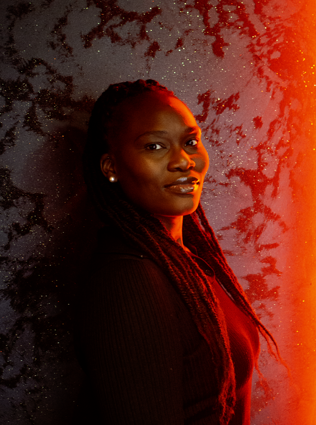 Headshot for female founder lit by red neon bar