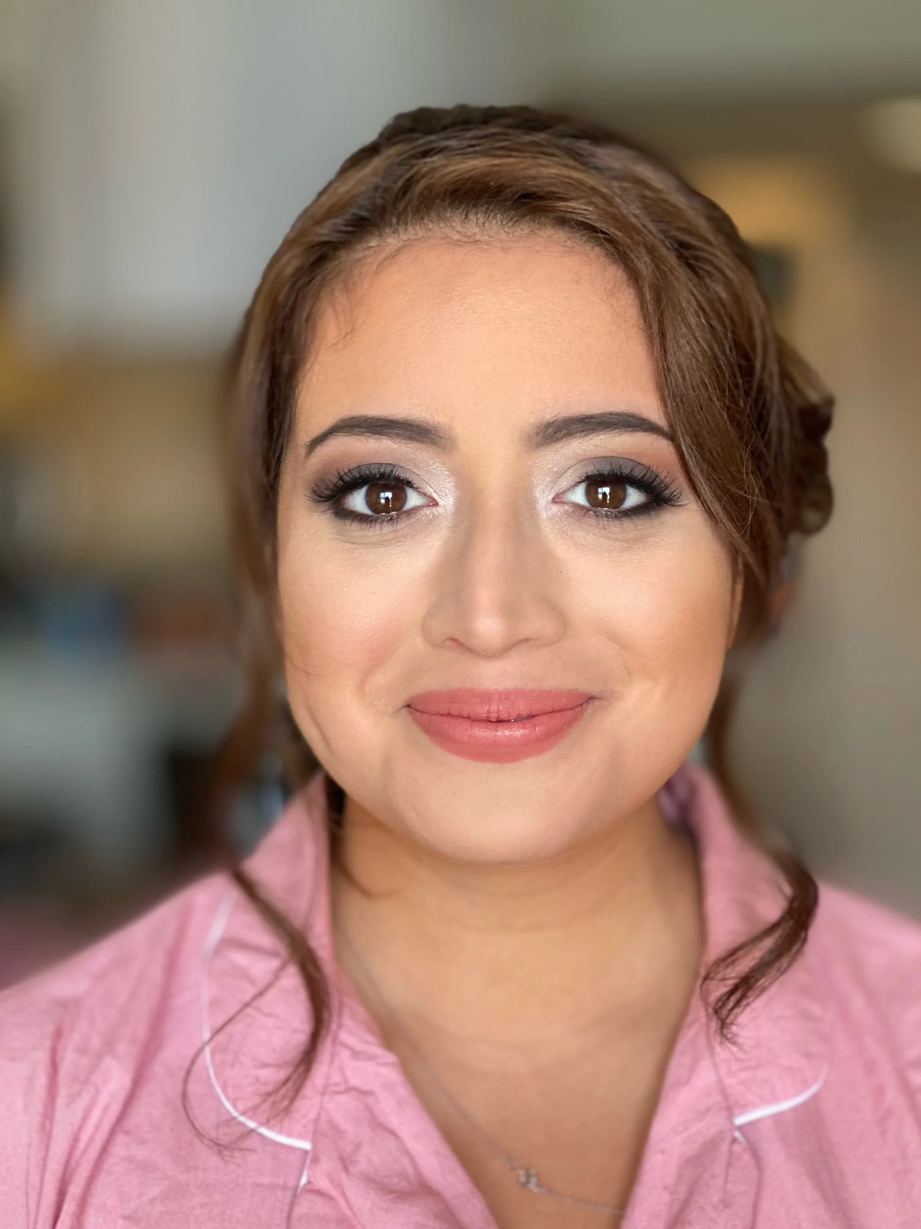 Smiling bride-to-be looks glowing after getting her makeup done