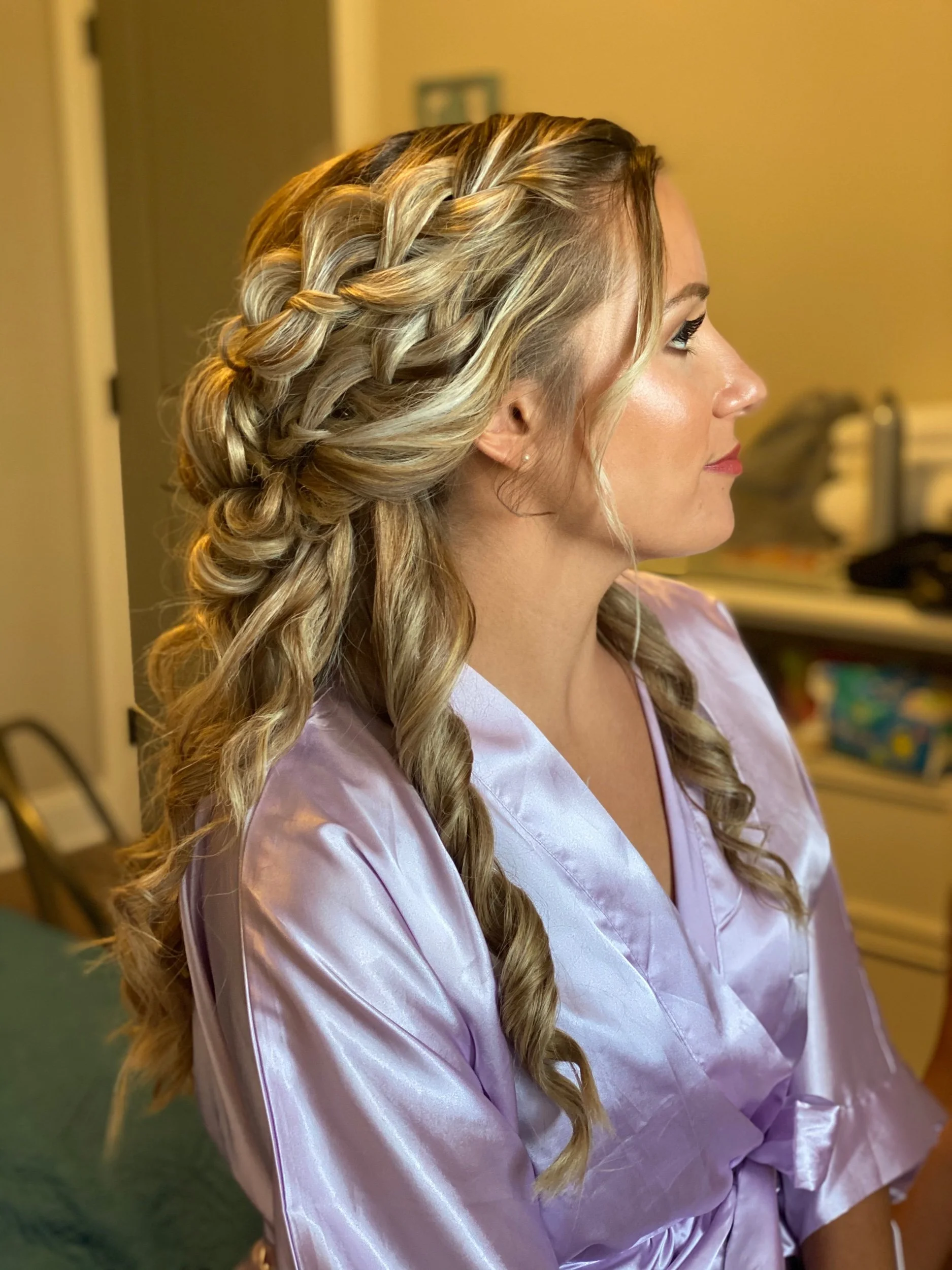 Romantic loose braid hairstyle done on a bride-to-be