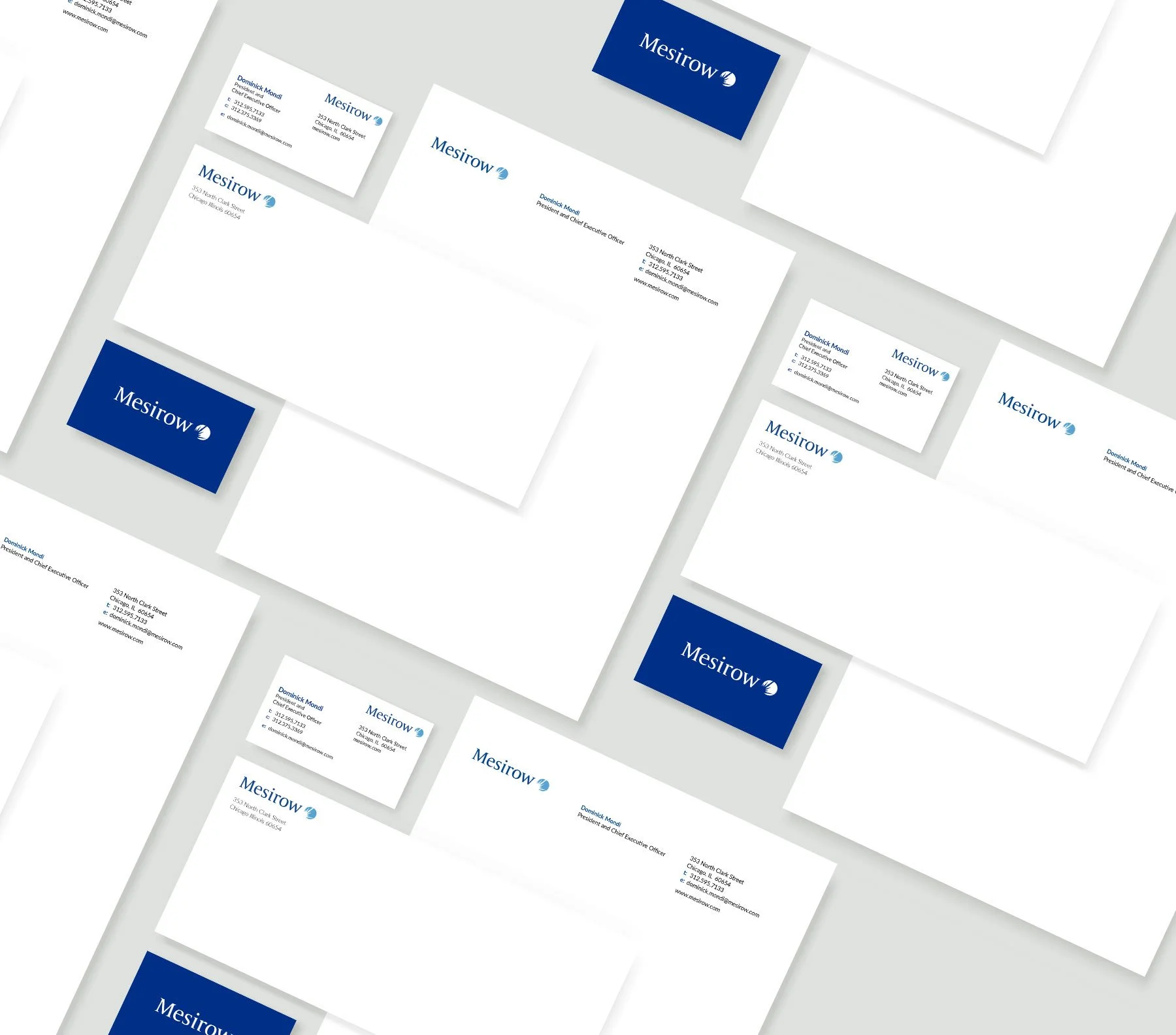 Set of corporate branding materials including business cards, letterheads, and a notebook, all featuring the Mesirow logo in blue and white.