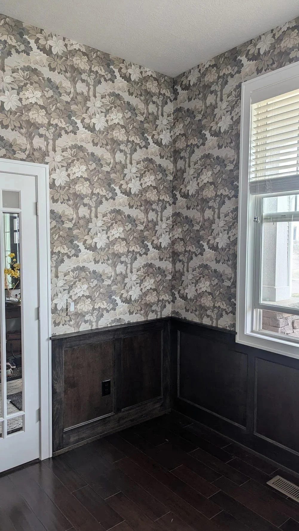 A wall with fresh wainscoting and wallpaper