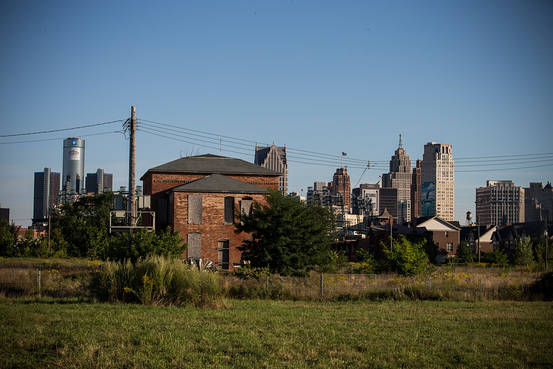 An abandoned home is seen with the Detroit skyline in the background. GETTY IMAGES