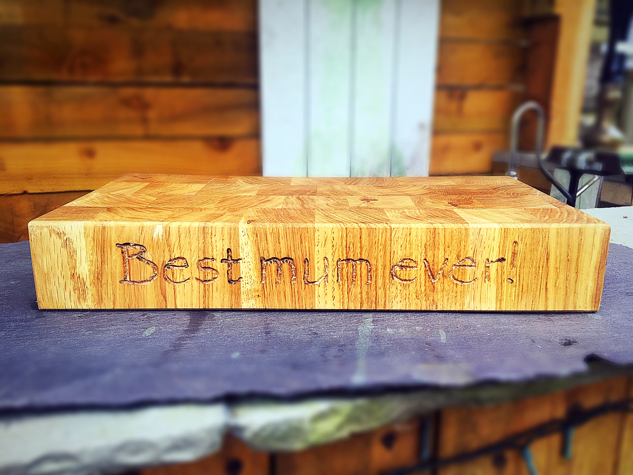 This beautiful board was created for a mum who’s children wanted to get her a wood gift for Mother’s Day to last a lifetime, in the form of a solid beech end grain butchers block with personalised engraving. Custom made to fit specifically in a special place on the kitchen worktop for her favourite teapot and accessories.