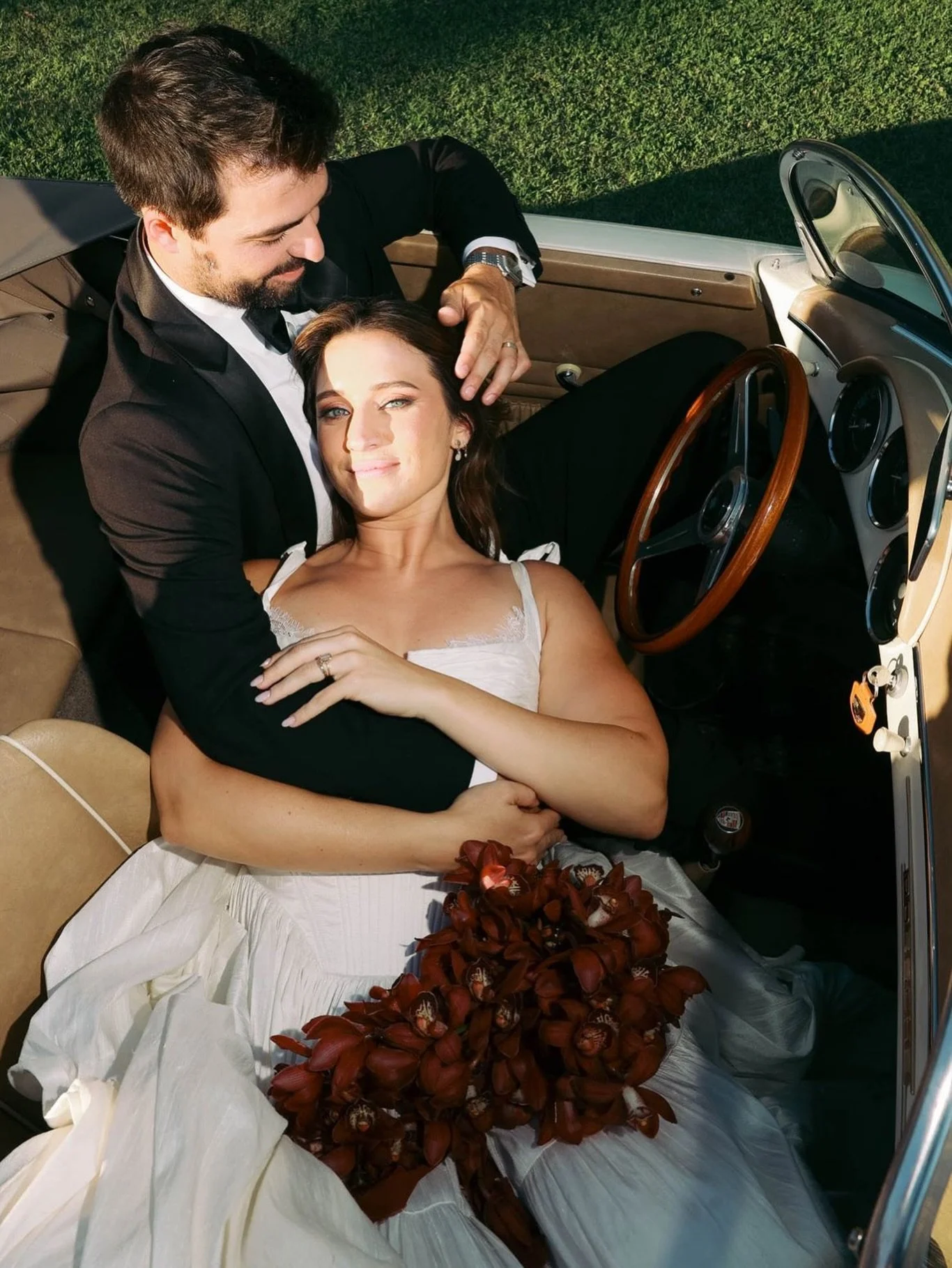 Orchids romance 🖤

Her. That bouquet. That light. 
Deep burgundy orchids cascading down, a vintage car, a glass of champagne sometimes, a single image says it all.

Botanique Bazar is back -> remaining dates for your 2026 weddings.
📩 Let&rsquo;s