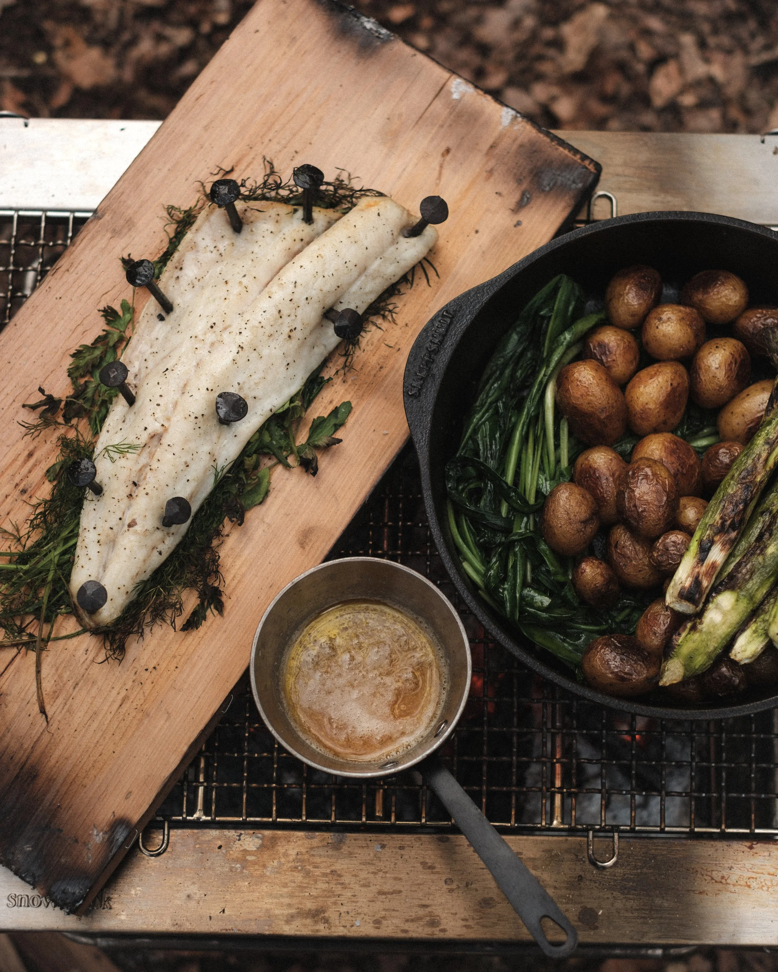 Cedar plank cooking over open fire