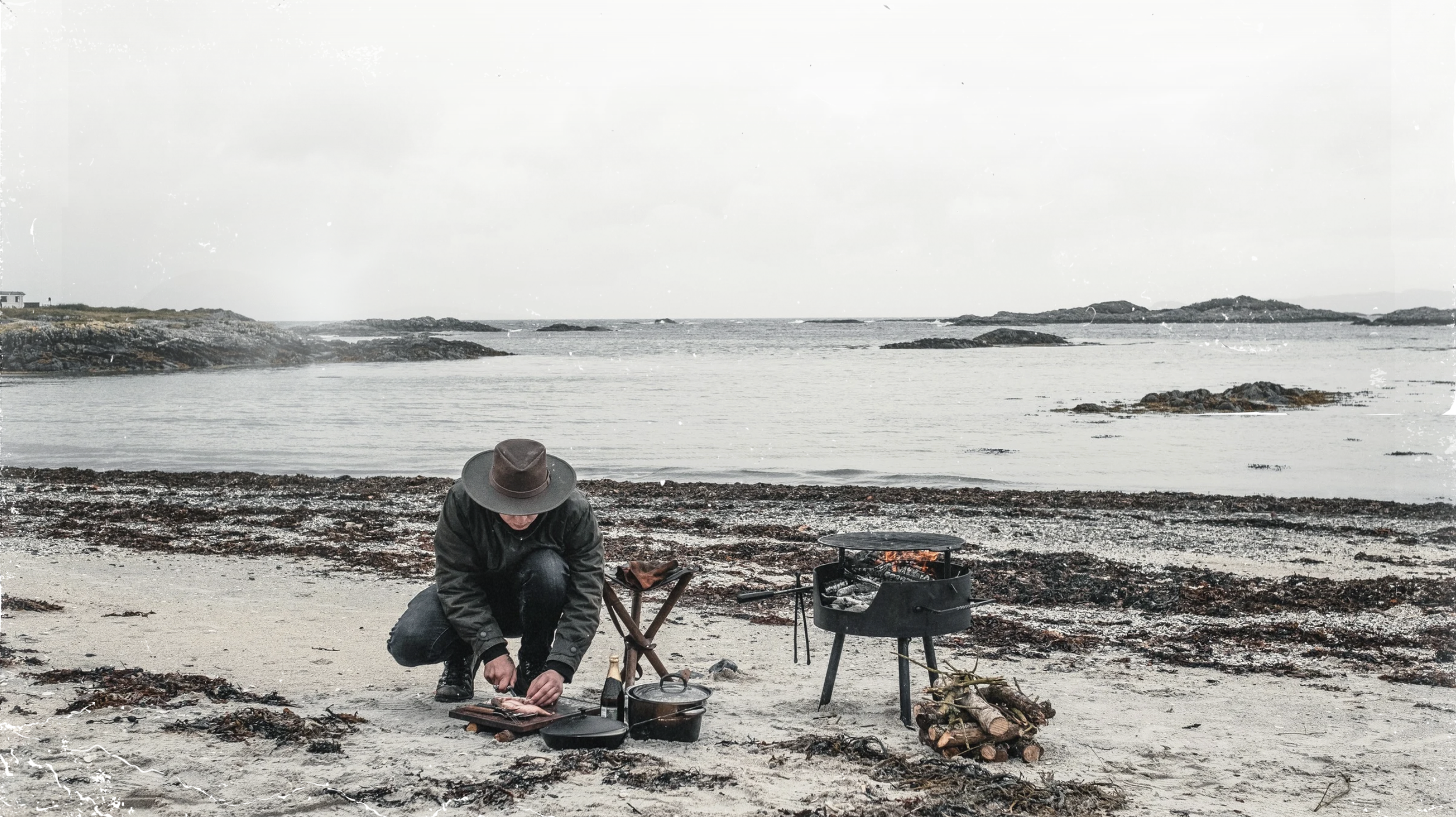 Cooking over fire on a remote beach.png
