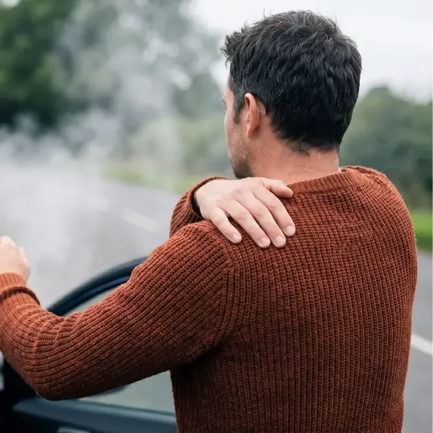 Man experiencing shoulder pain after collision needing a car accident doctor in Guthrie, Oklahoma