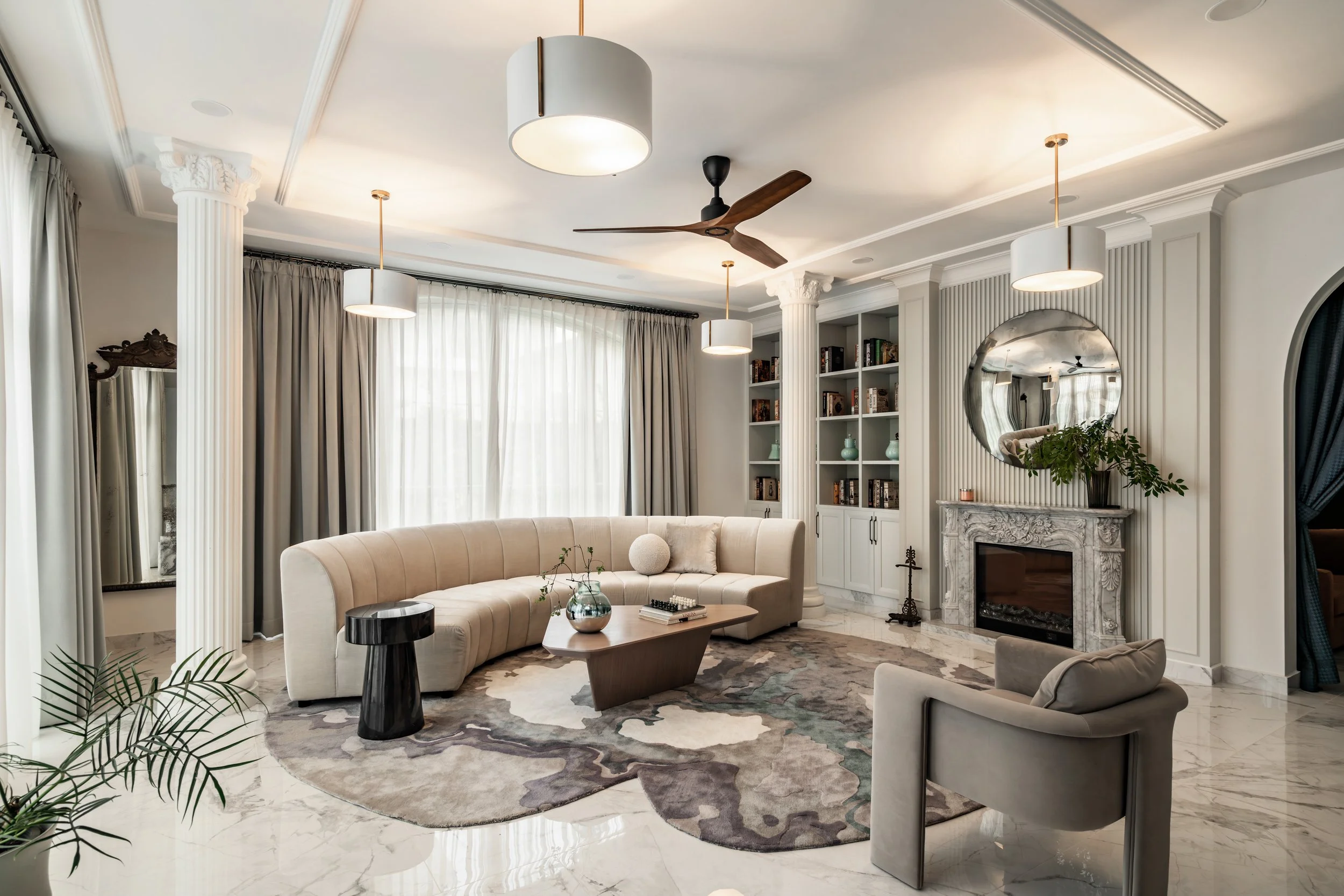  The formal living room at Arch House is a delight to the senses - there is much to explore, even within its light neutral palette.  The first thing that catches the eye is the irregularly-shaped rug that weaves together an array of diverse forms - a