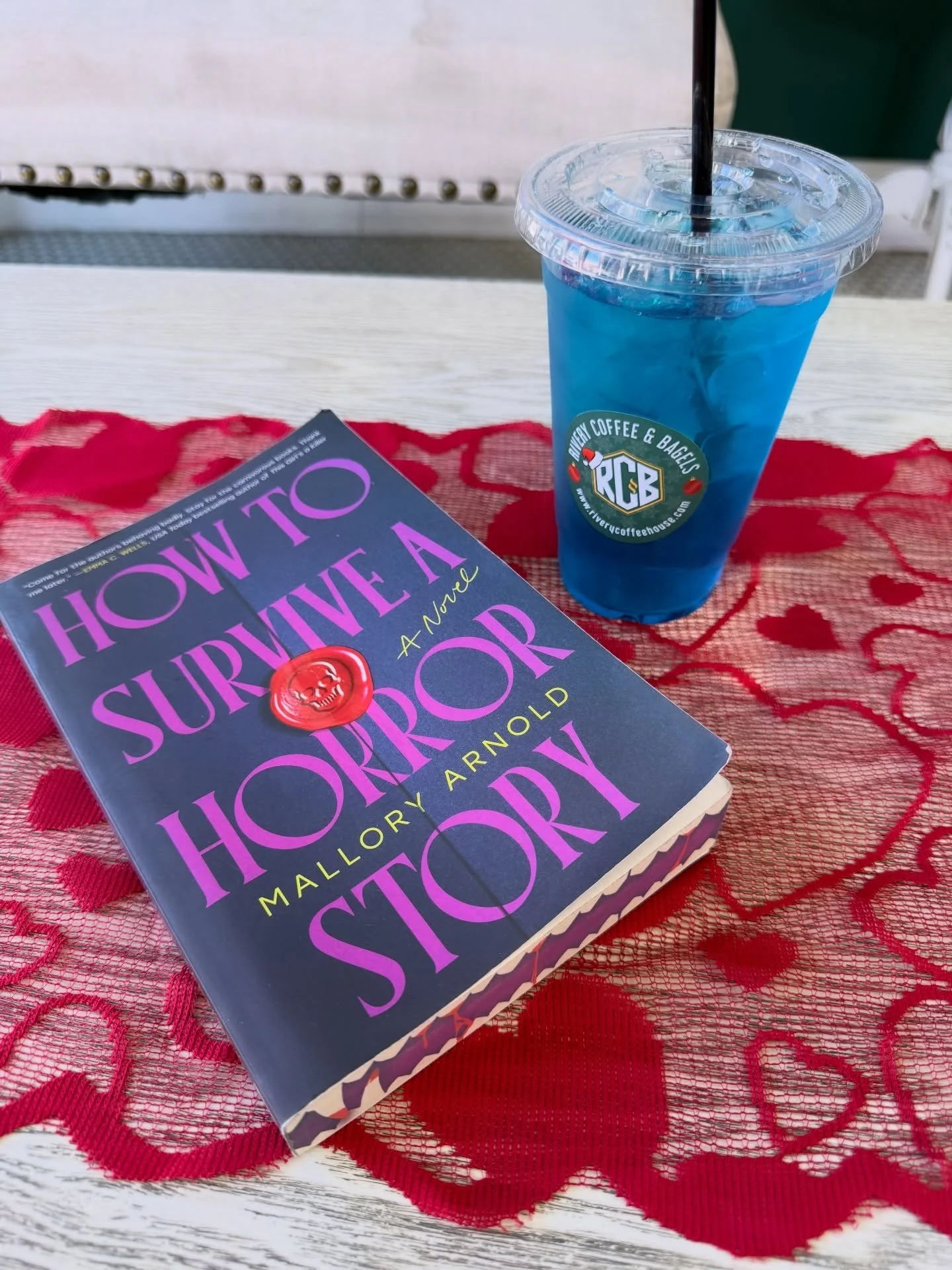 A book and a refreshing Lotus Energy Drink from @riverycoffeeandbagels is the perfect way to spend a Saturday afternoon 💜 #berrylicious 
#malloryarnold 
#bookstagrammer 
#horrorbookstagram 
#howtosurviveahorrorstory
