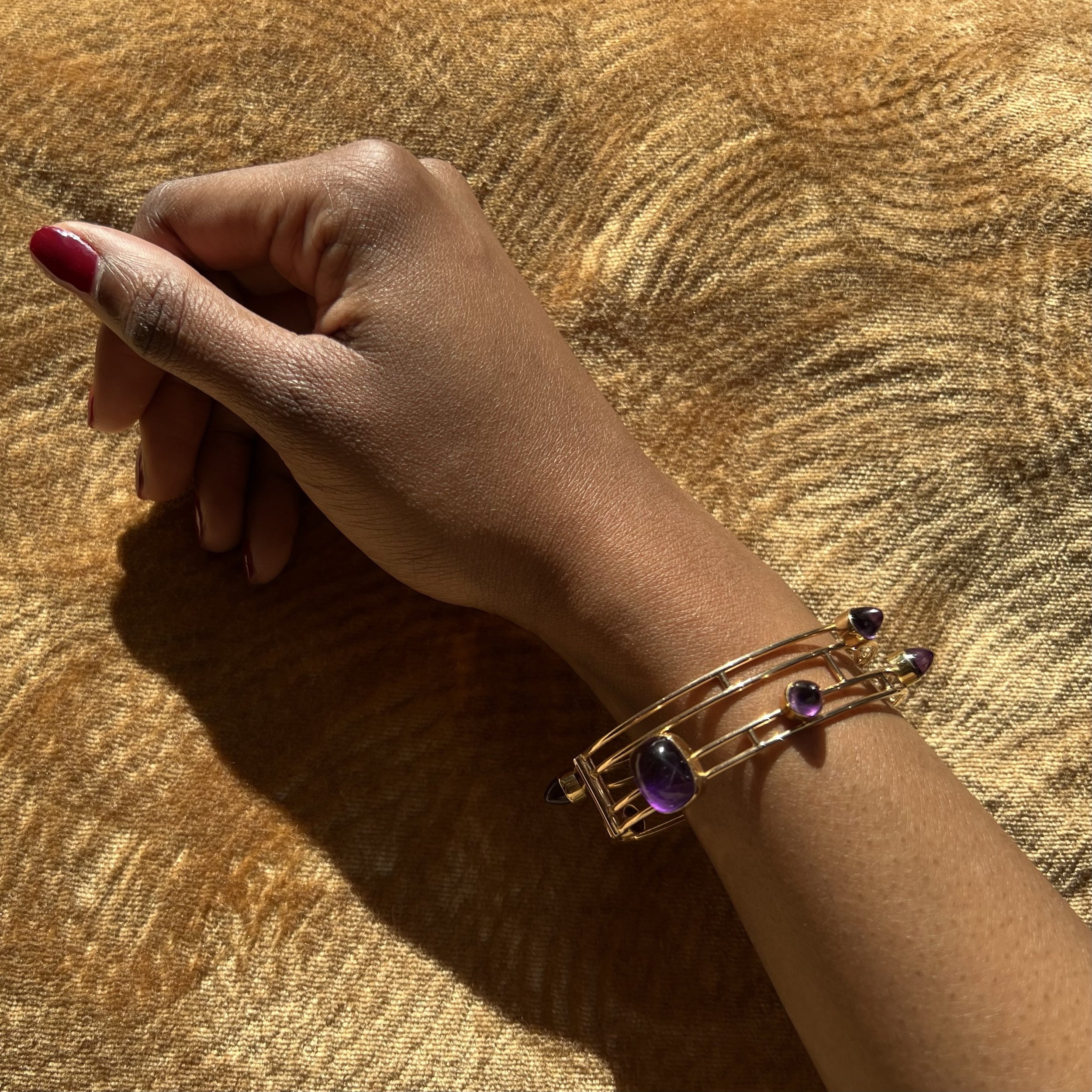 A bullet cabochon amethyst and 14 karat gold bangle, by Bent and Anni Knudsen, Denmark, 1960-1970