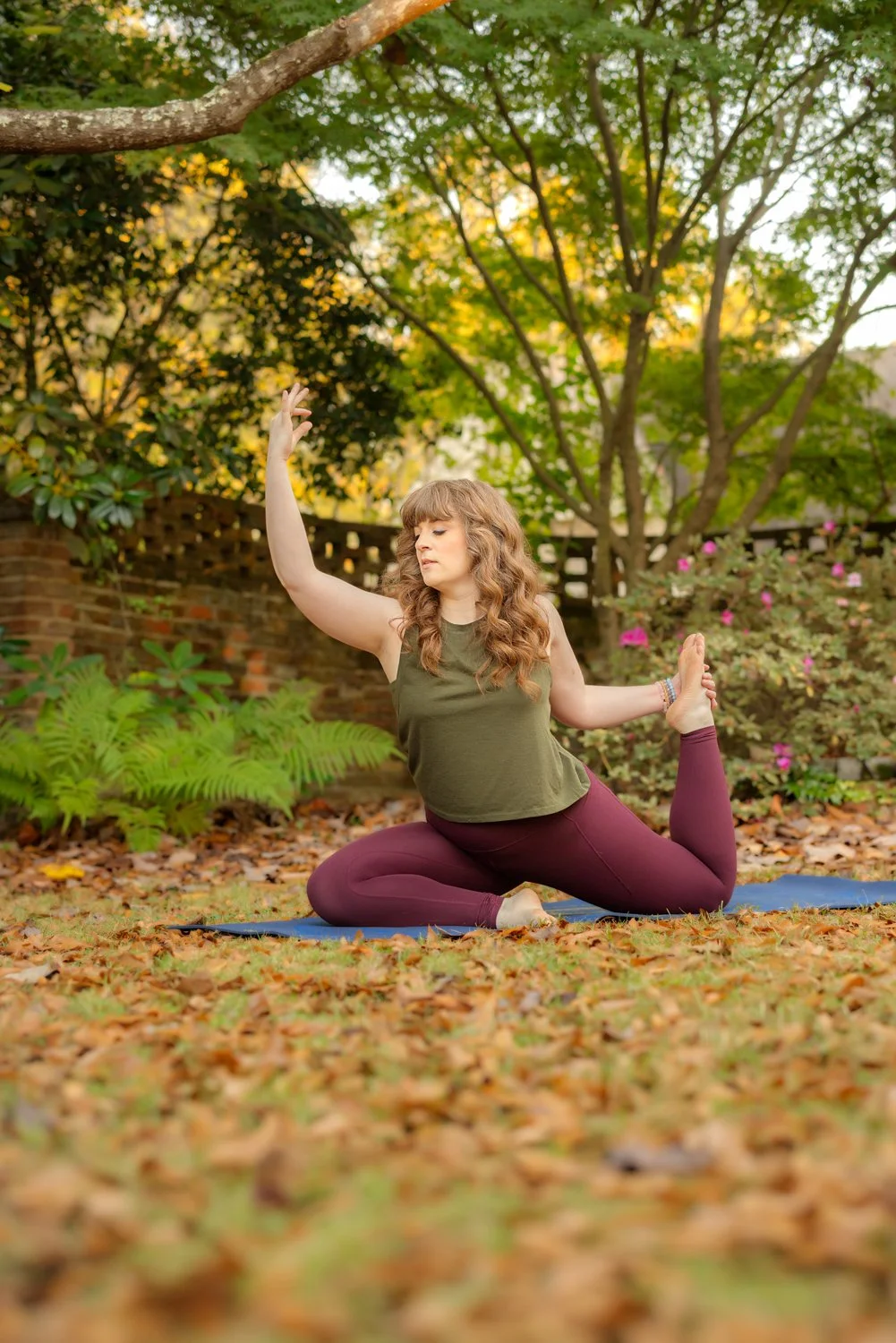 A woman does a variation of the mermaid yoga pose during a photo session in Pike Road, Alabama with m.Clemm photography