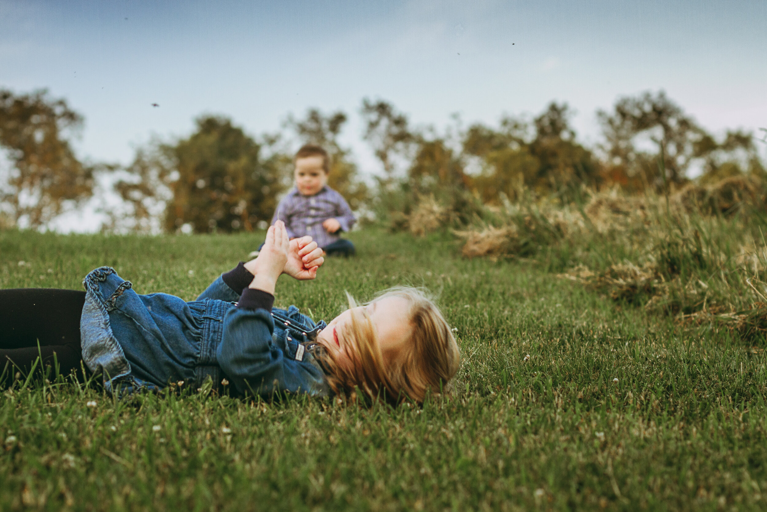 m.Clemm photography | Montgomery, Alabama family photographer | little girl rolls down a hill while brother watches.jpg