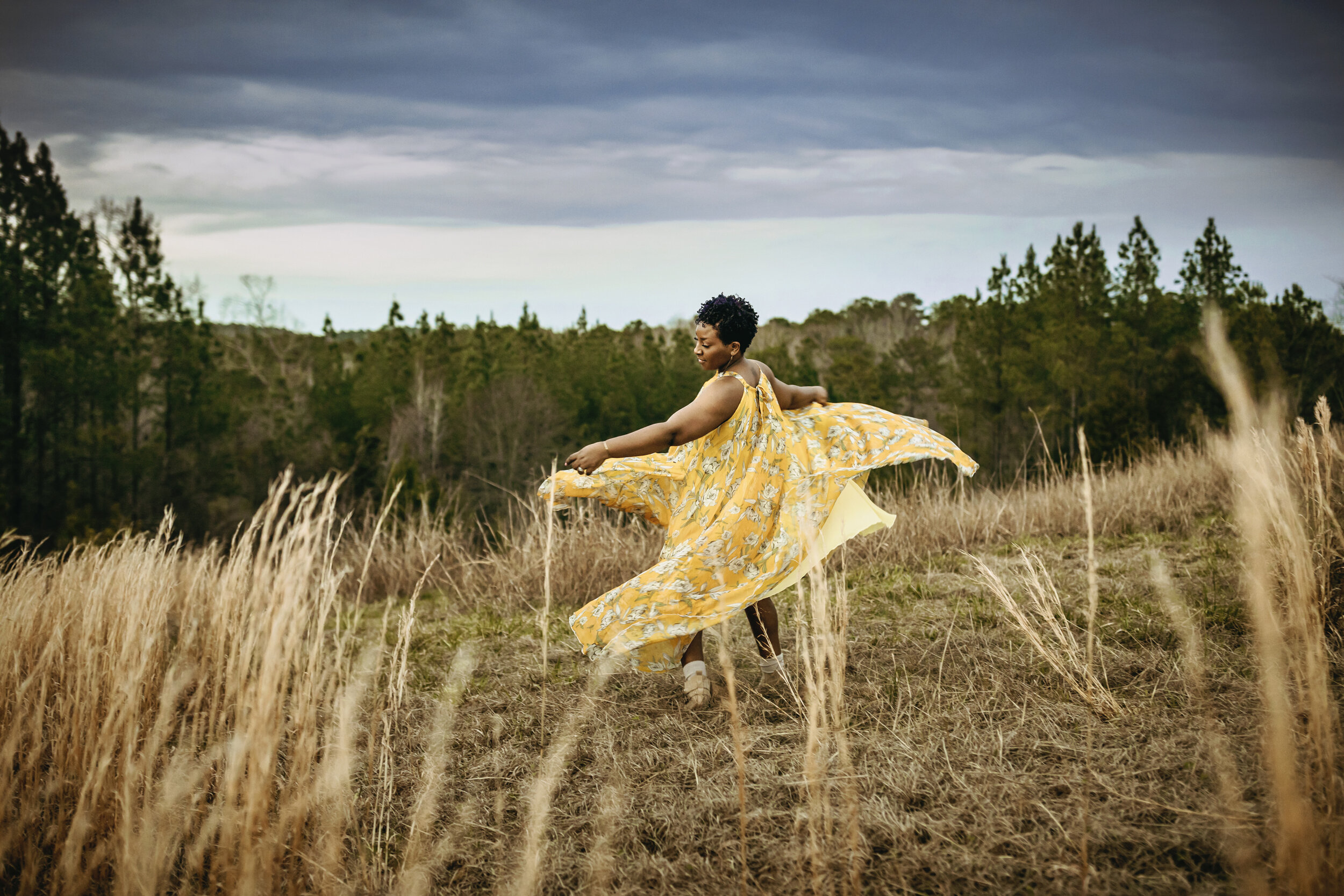 m.Clemm photography | Montgomery, Alabama photographer | woman twirling in a yellow dress in Lake Martin, Alabama.jpg