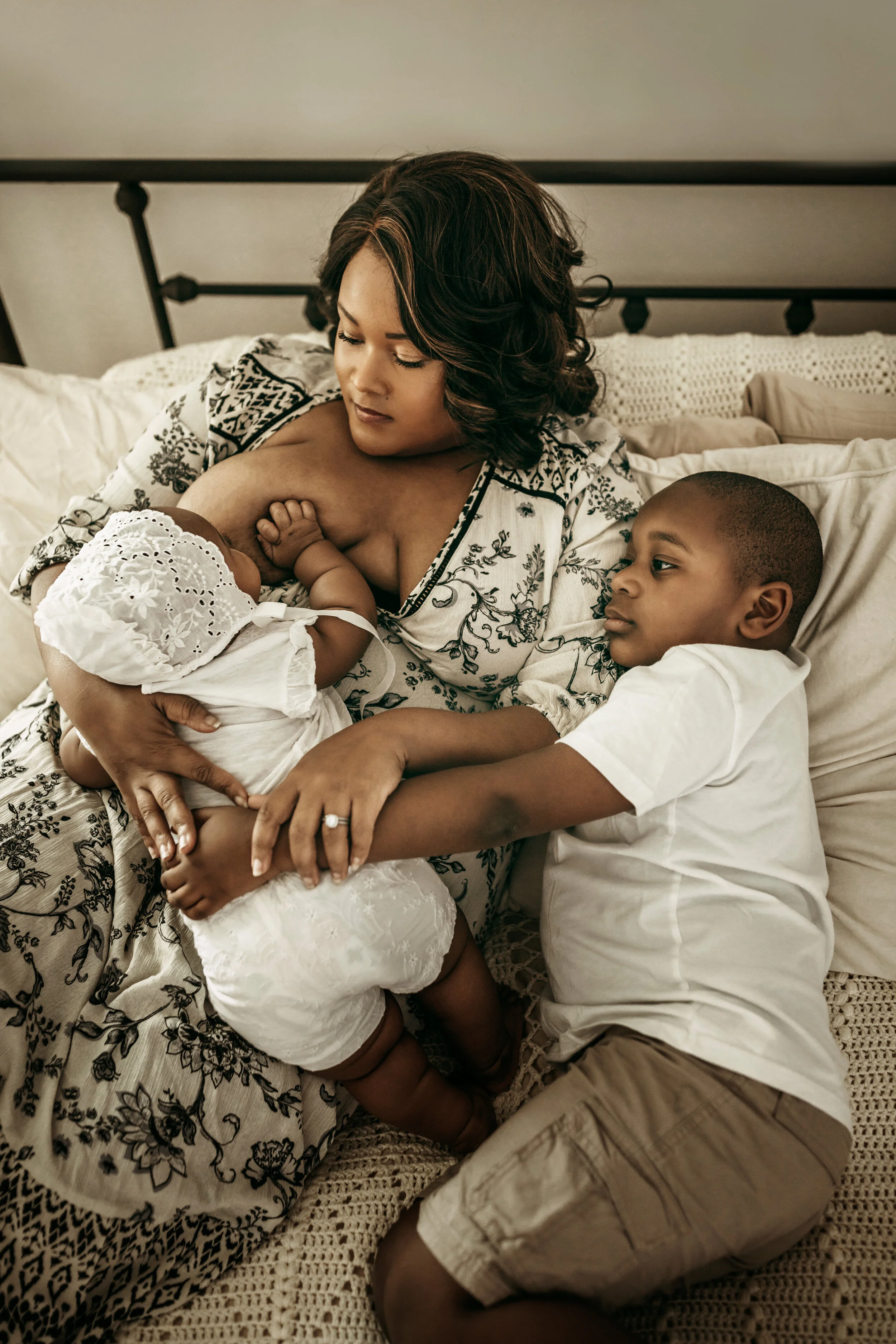 Montgomery Alabama Photographer - A mother cuddles with her son while nursing her baby in Pike Road, Alabama