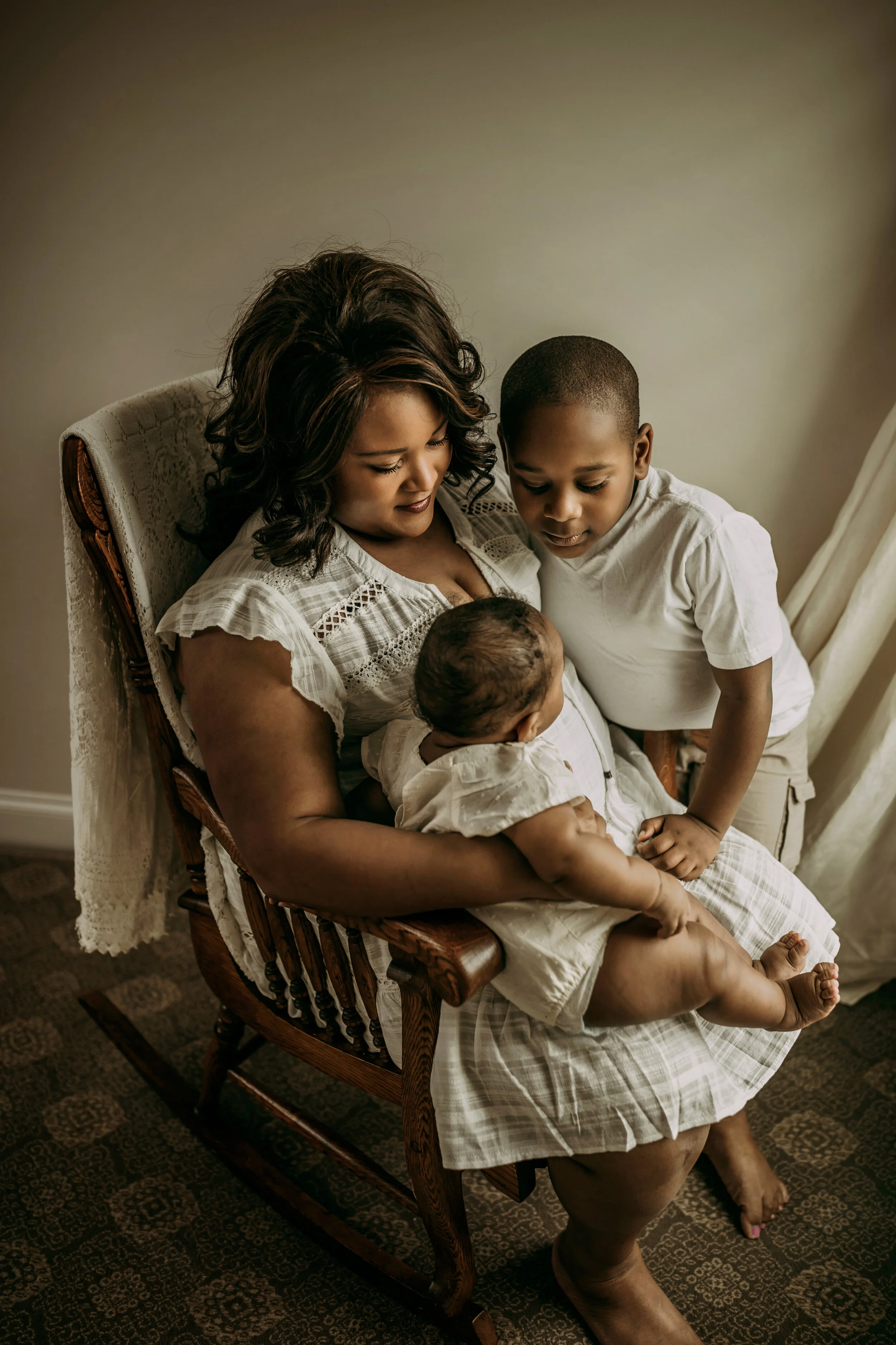 Montgomery Alabama Photographer - A mother sits in a rocking chair with her young son and daughter in Pike Road, Alabama