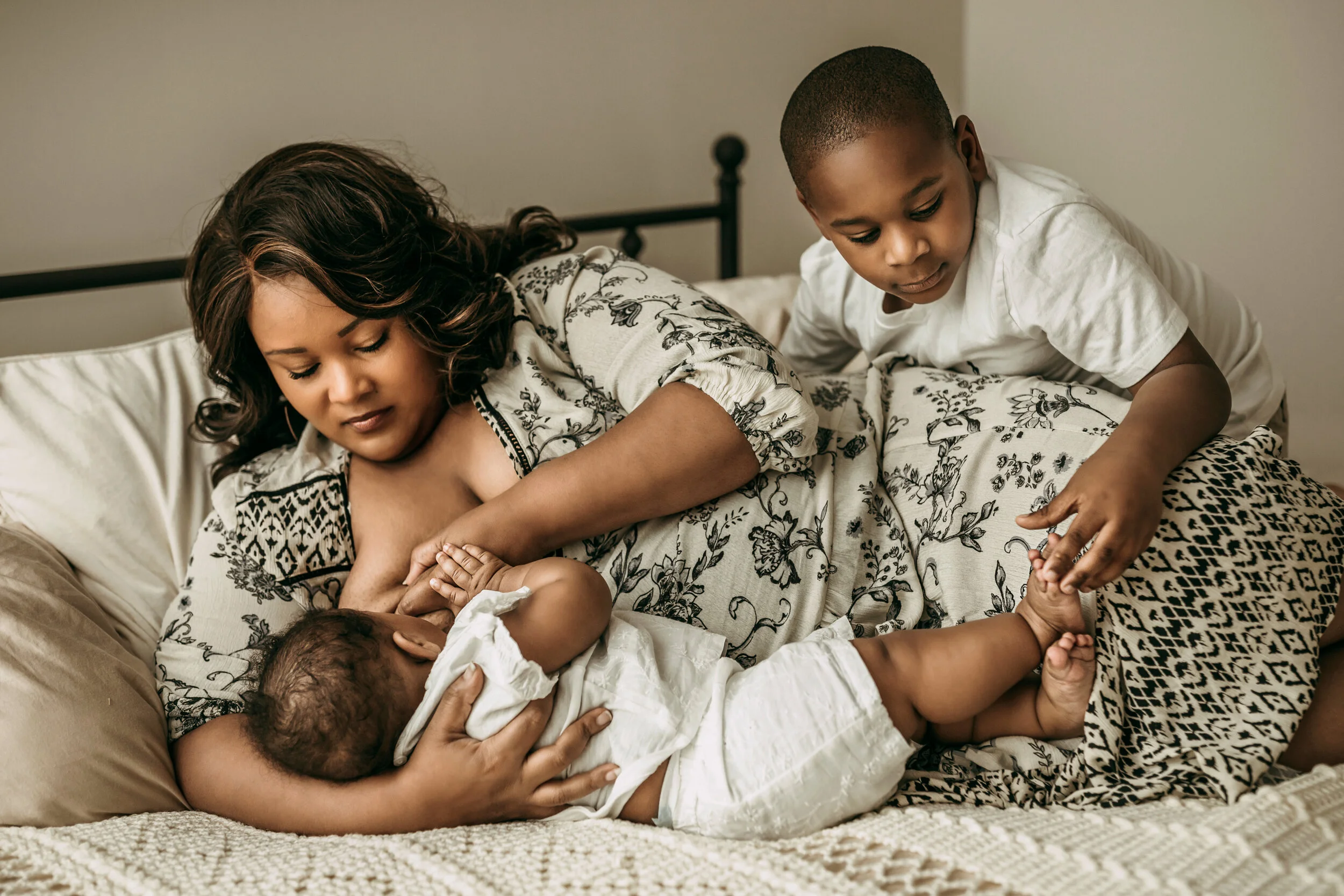 Montgomery Alabama Photographer - a mother nurses her daughter as her son play’s with his sister’s toes in Pike Road, Alabama