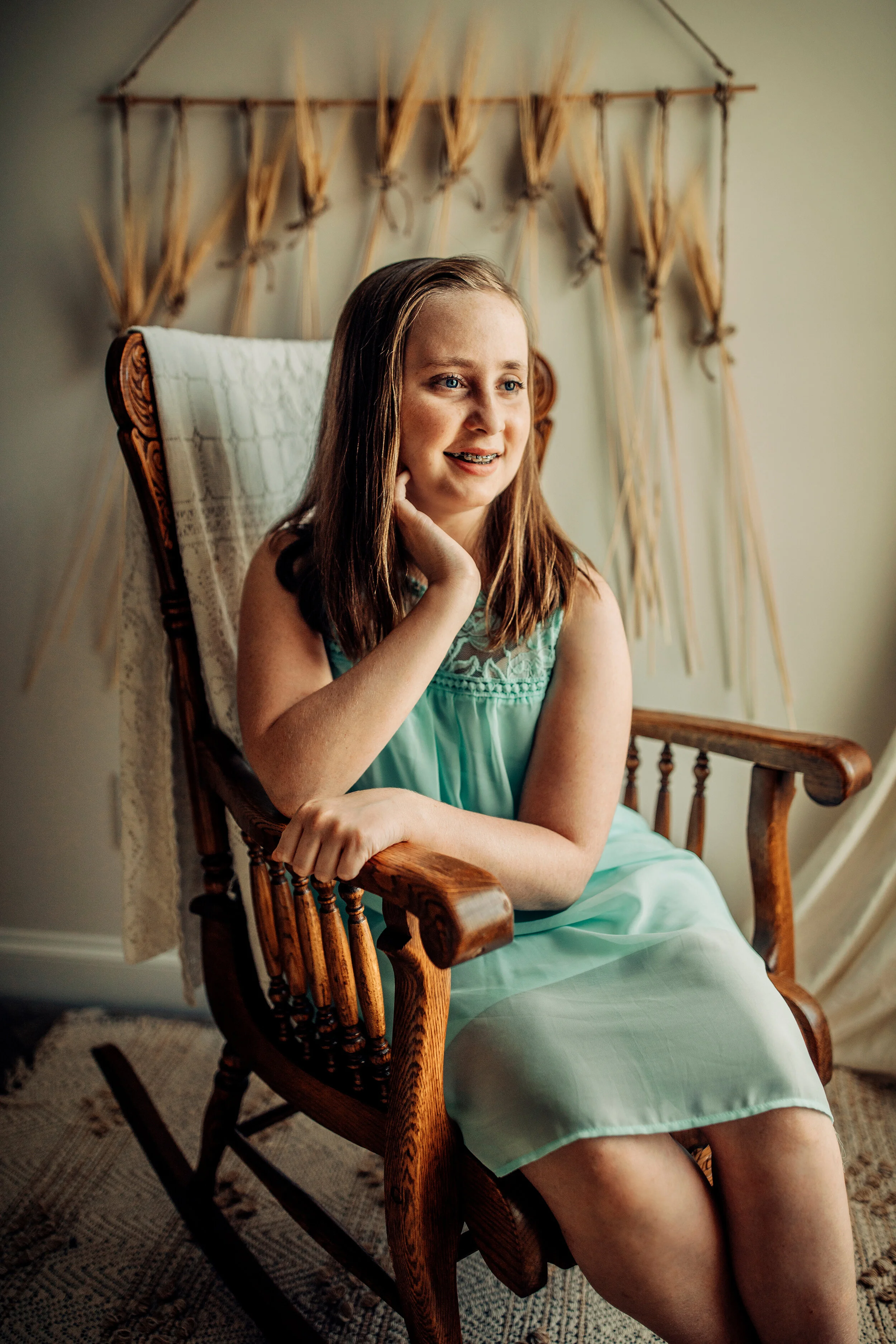 Montgomery Alabama Photographer - a girl sits in a rocking chair and looks out the window in Pike Road, Alabama