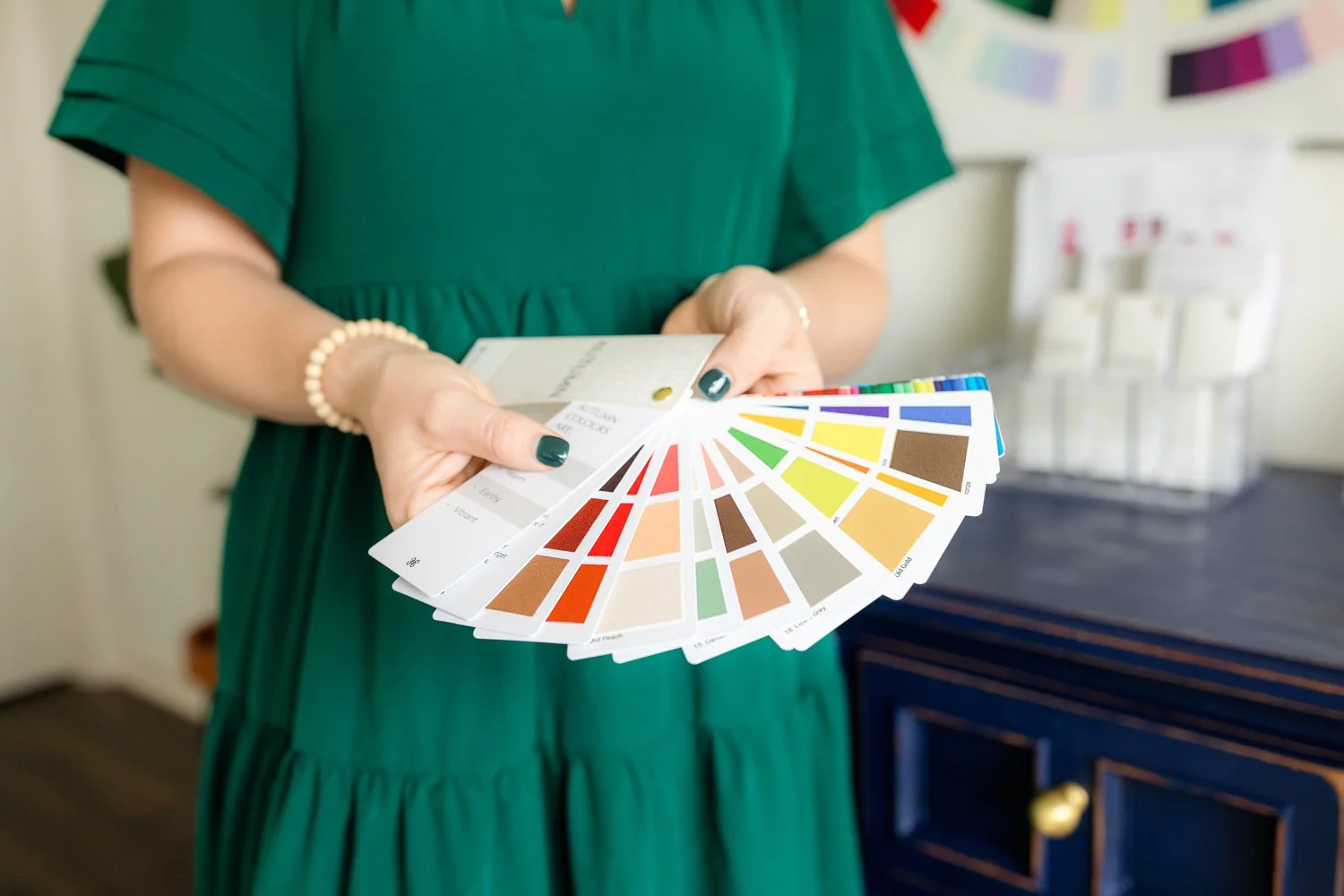 A woman holds a color swatch book for color analysis in a branding photo session with Pike Road Photographer, m.Clemm photography