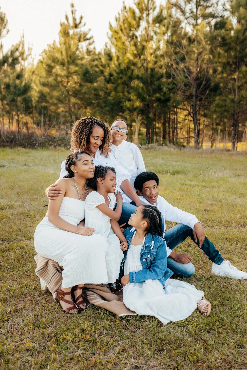 A grandmother cuddles with her grandchildren near Lake Martin, Alabama during a photo session with Montgomery Photographer m.Clemm photography