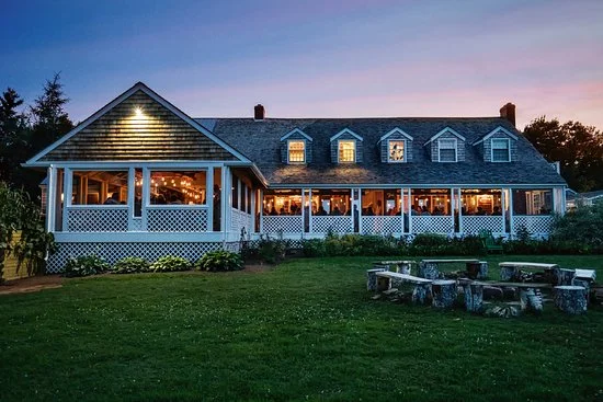 Guests enjoying the Fireworks culinary experience at the present day Inn at Bay Fortune.