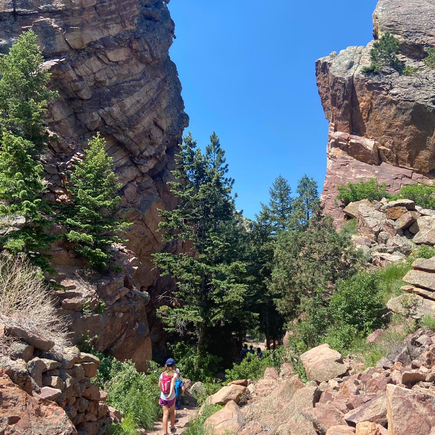Not too long after we passed through this narrow path between two towering cliffs, my eyes caught a glimpse of two climbers dangling in mid air while in pursuit of the summit.

Evidently the Eldorado Canyon State Park in Colorado invites rock climber