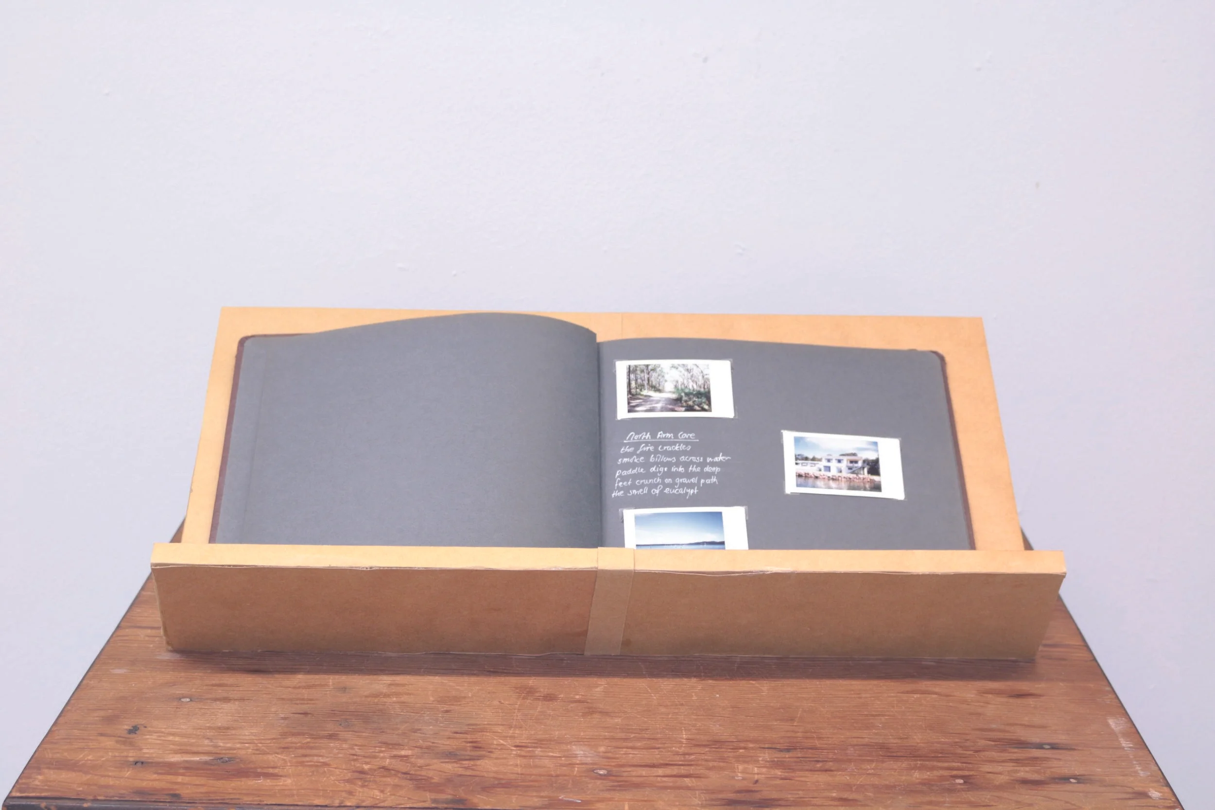  Sophie Cox, In memories light, 2017, album, photographs, wooden shelf, table, poetry. Image by Sophie Cox  When recalling a memory there is often a moment of light, that fills the minds eye as the moment is brought back from the memory store. It is 