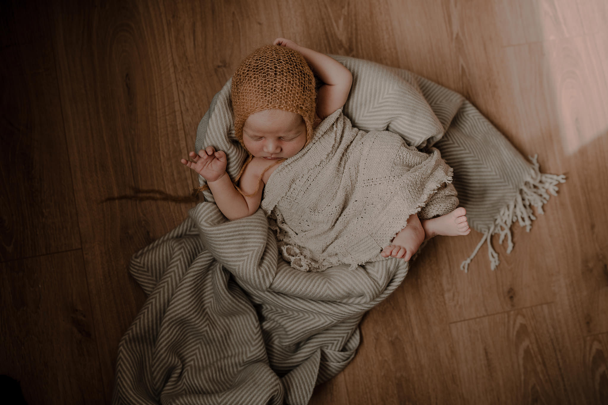 mustard bonnet and cream styling baby boy in home baby photographer Belfast