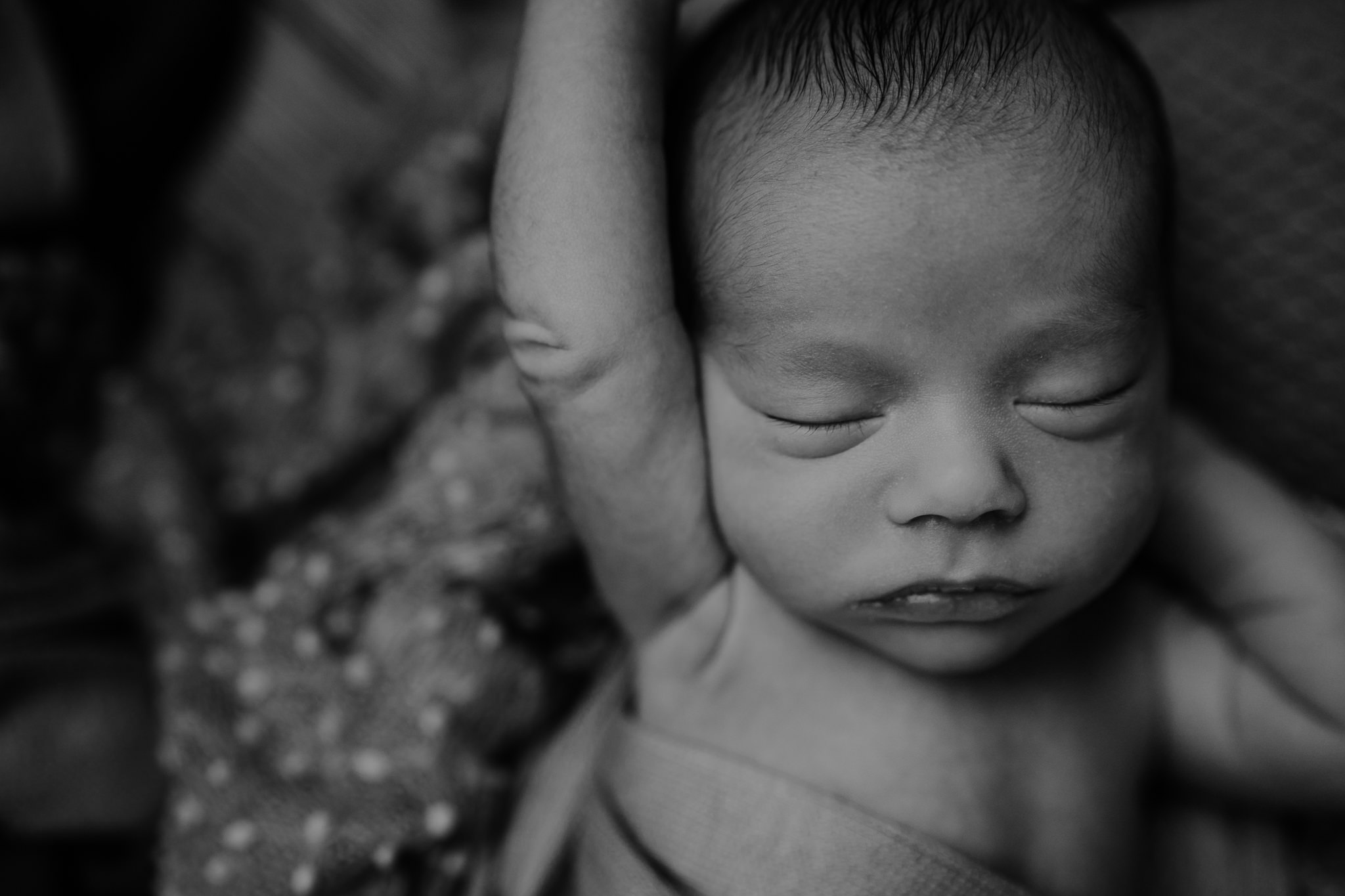 stretching newborn boy black and white