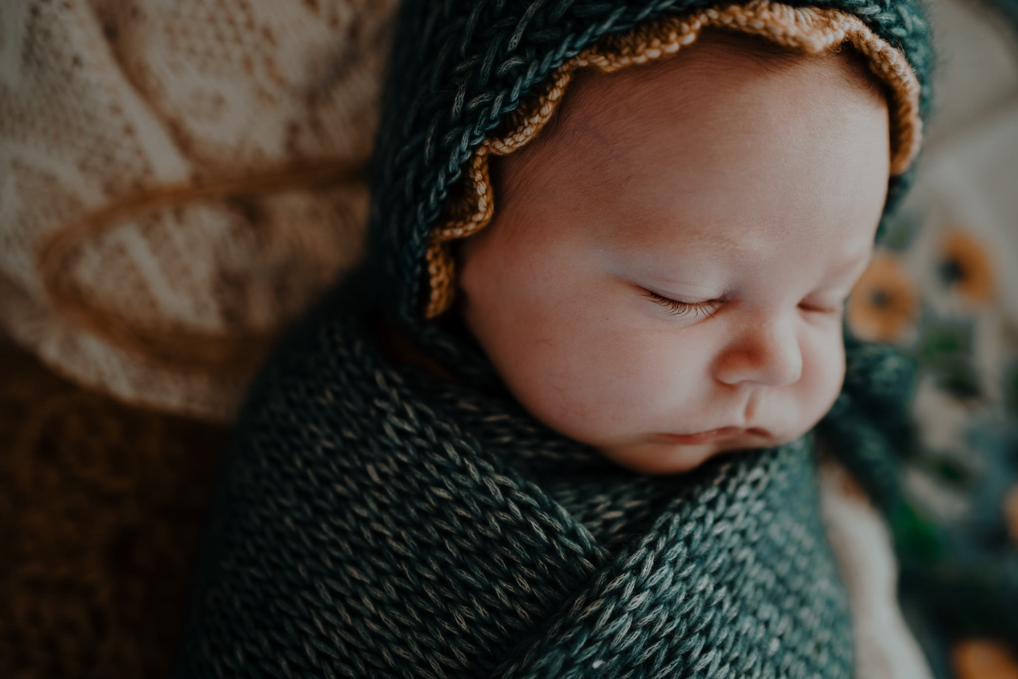 teal and mustard knit wrap and bonnets styled in home artistic baby photographer Belfast