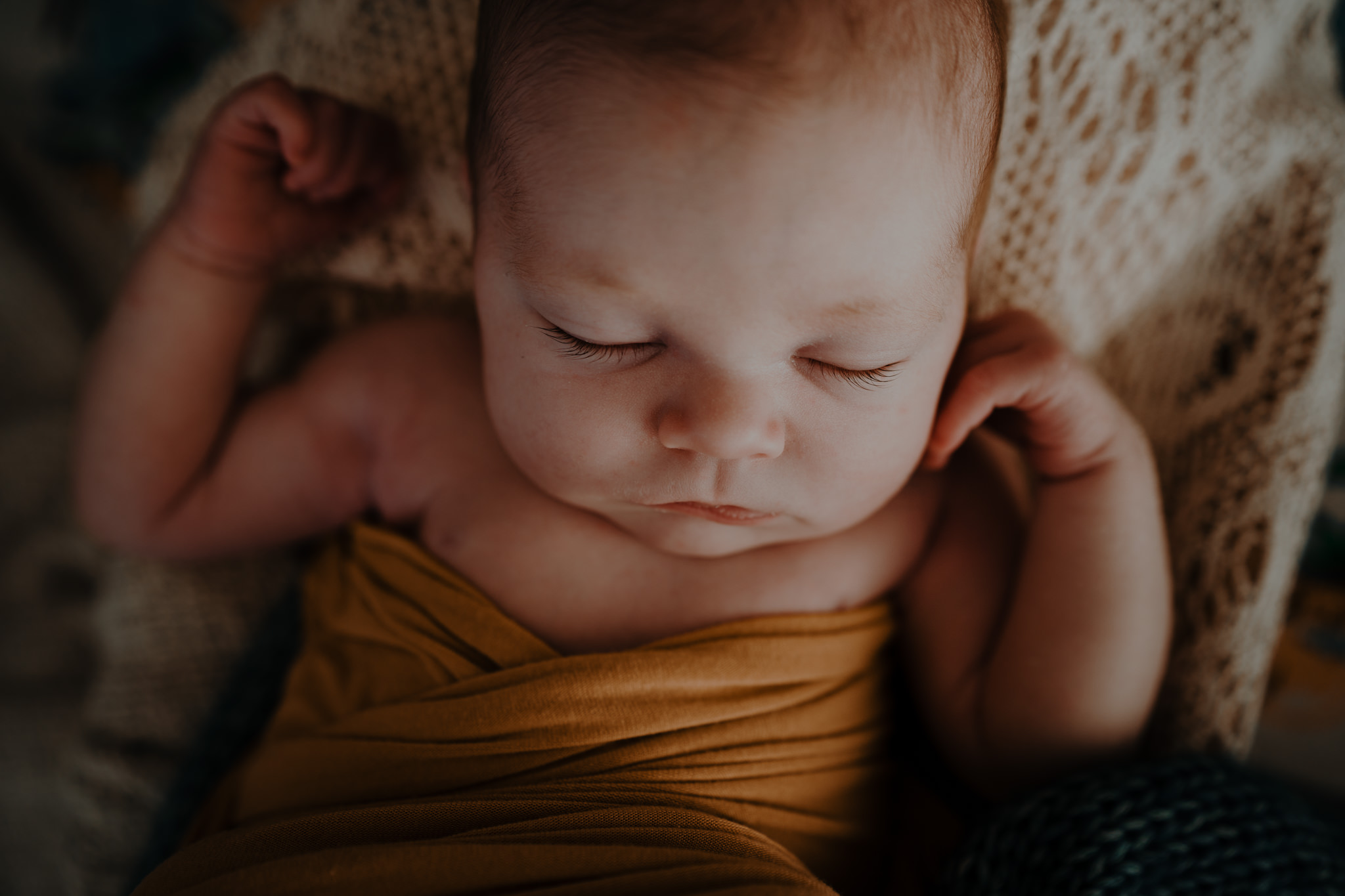 sleeping newborn baby eyelashes in mustard wrap fine art baby photographer Belfast