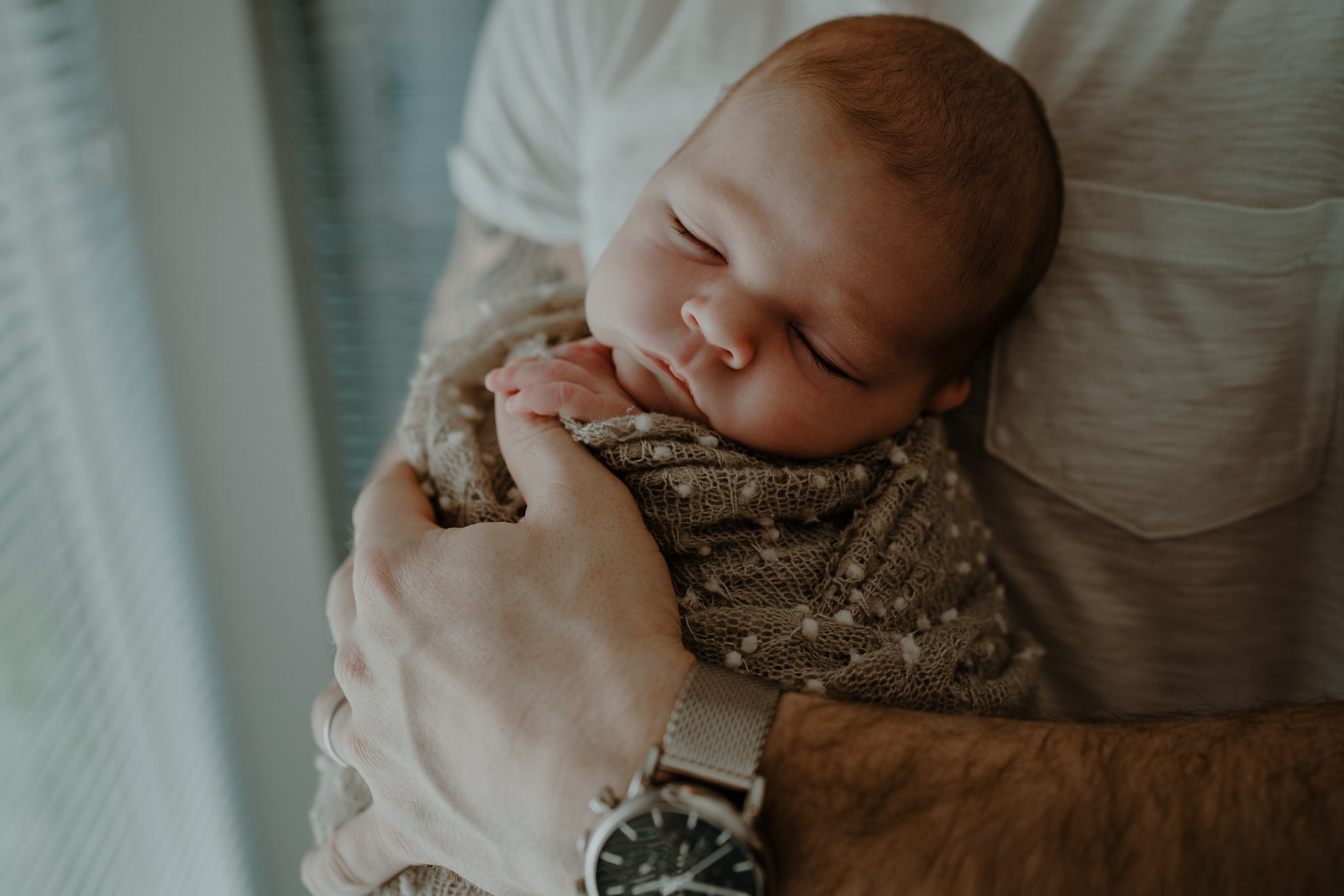 father holding baby artistic newborn photographer belfast