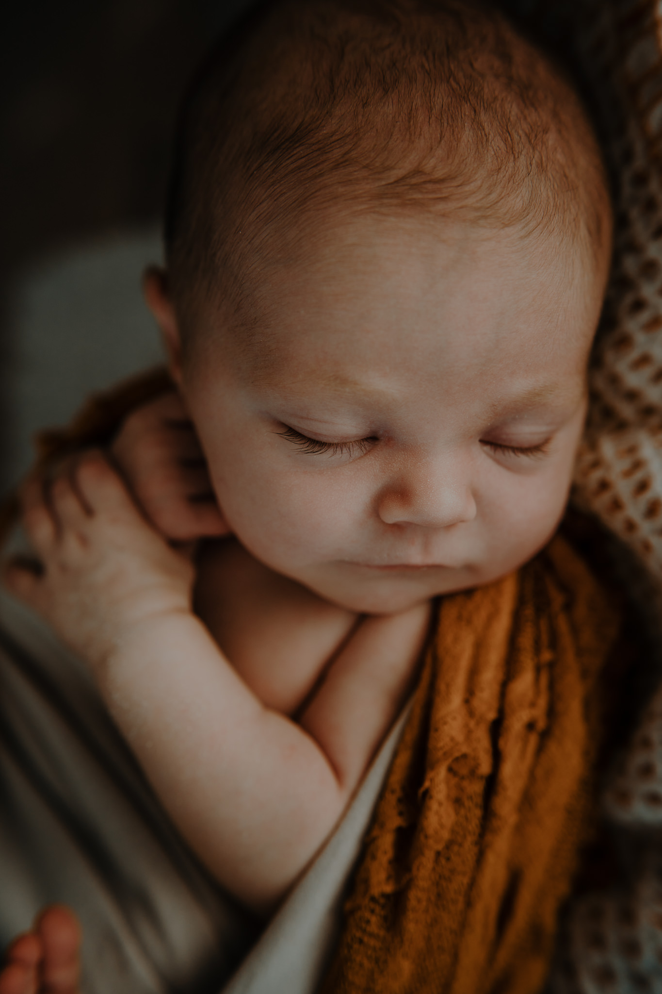 baby photographer Belfast sleeping newborn girl mustard yellow grey in home session