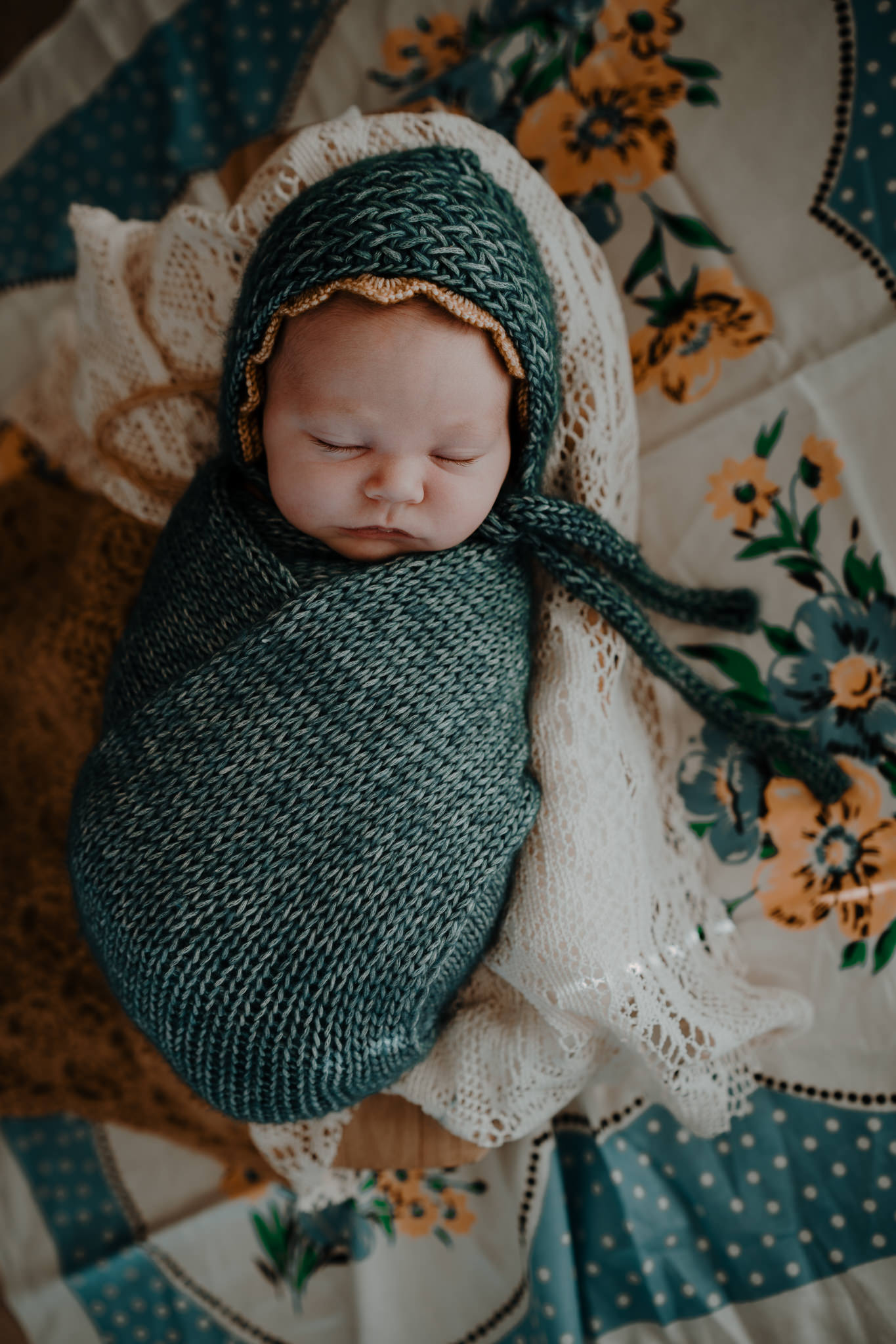 vintage tablecloth and knit wraps bonnets teal and mustard artistic newborn photographer belfast