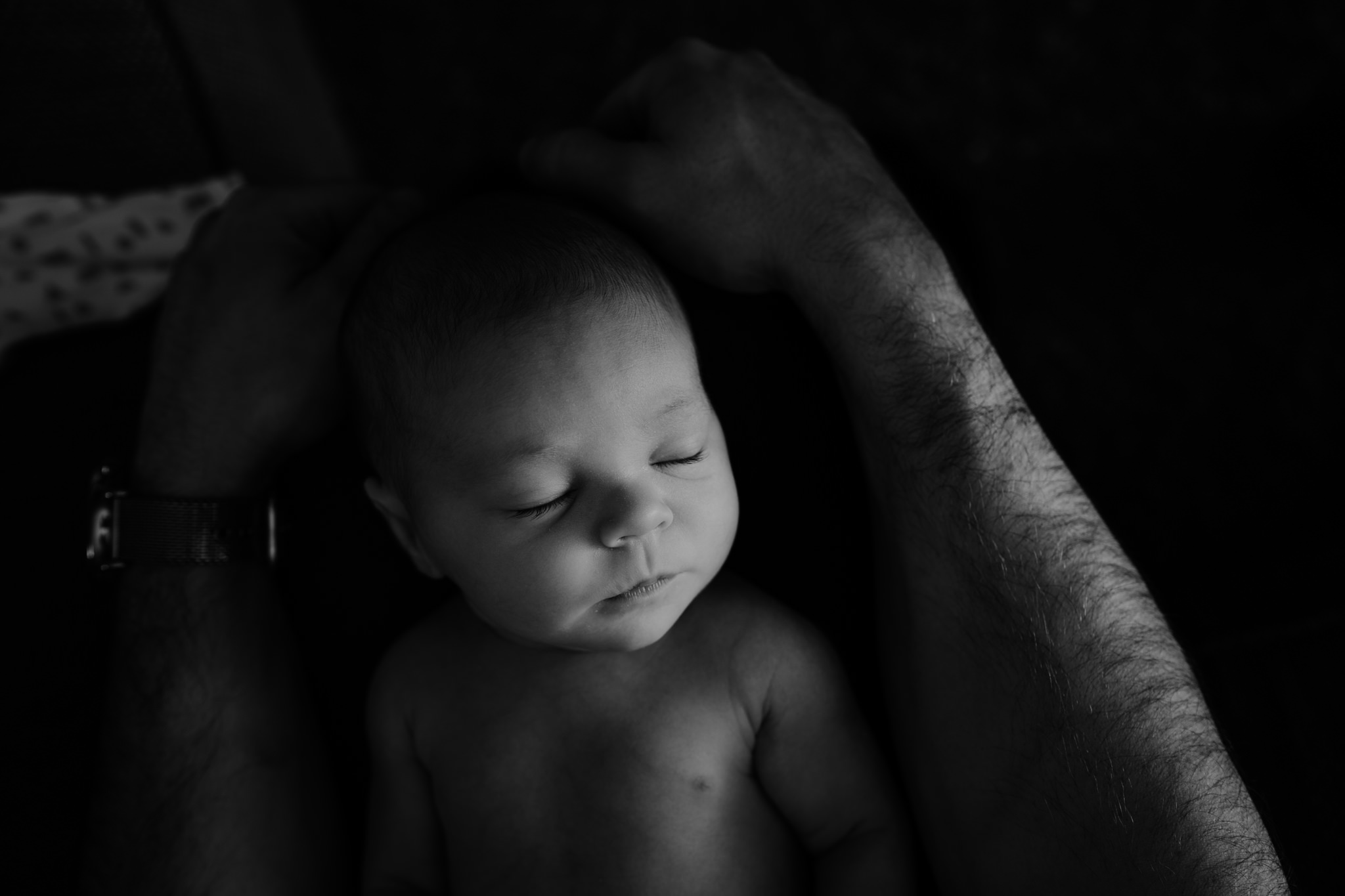 black and white newborn baby in dads arms artistic newborn photographer belfast