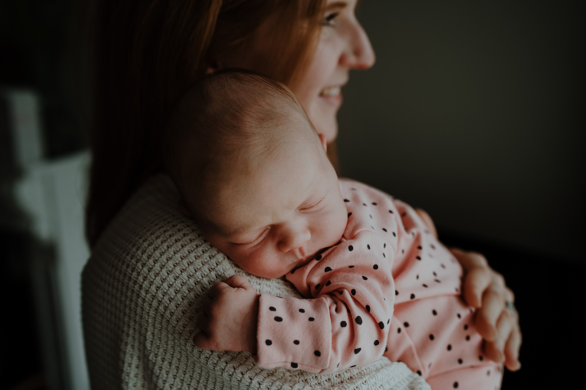 mother holding newborn baby girl pink babygro artistic newborn photographer belfast