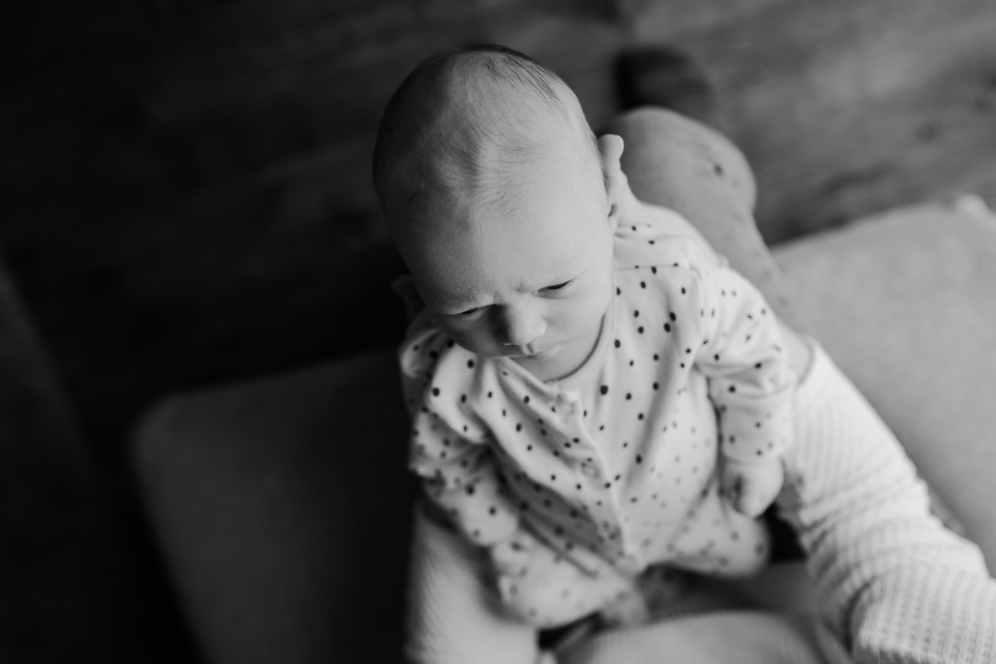 father holds newborn baby girl Black and white artistic newborn photographer belfast