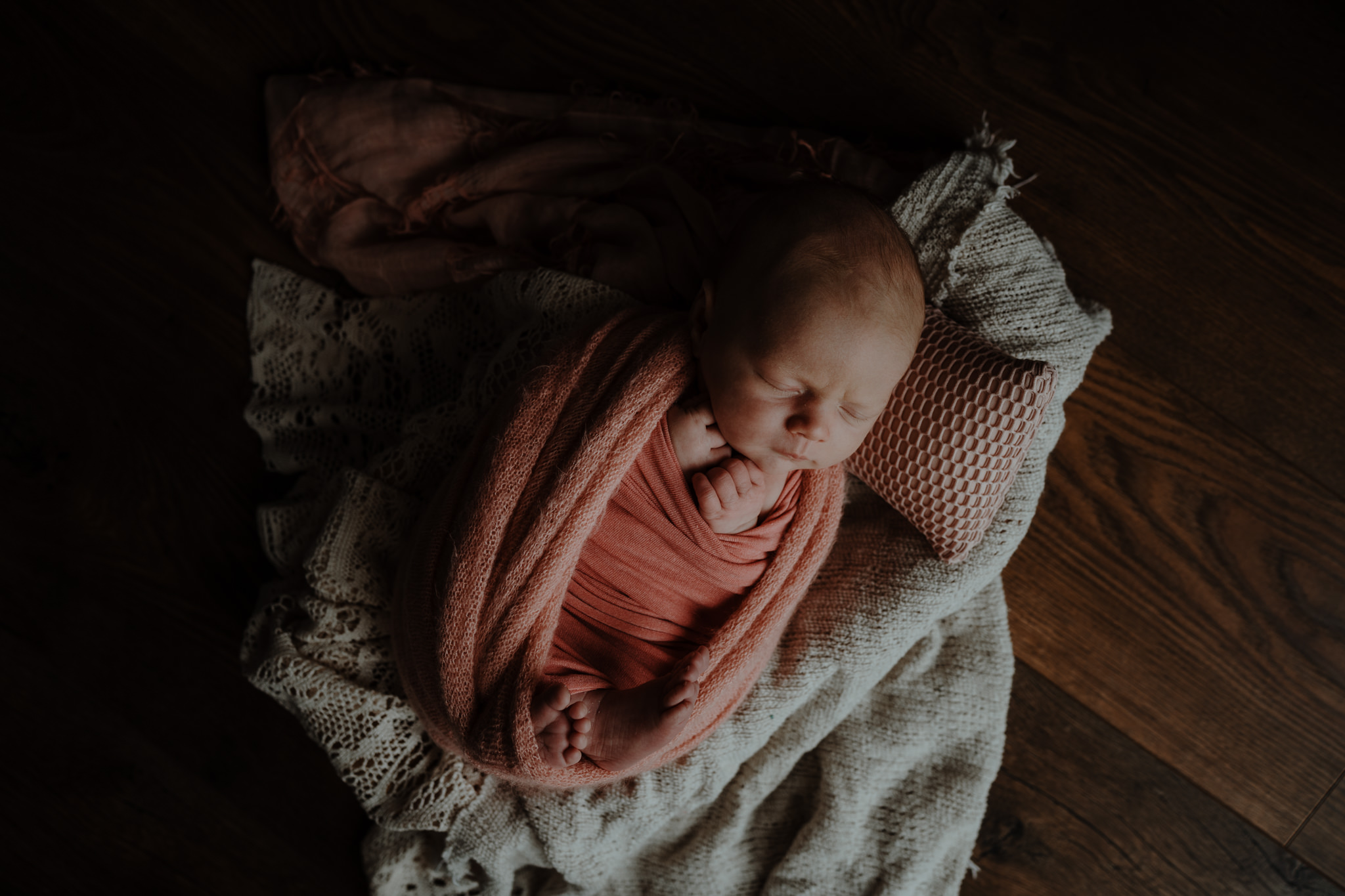 baby photographer Belfast peach pink cream layers newborn girl in home cosy