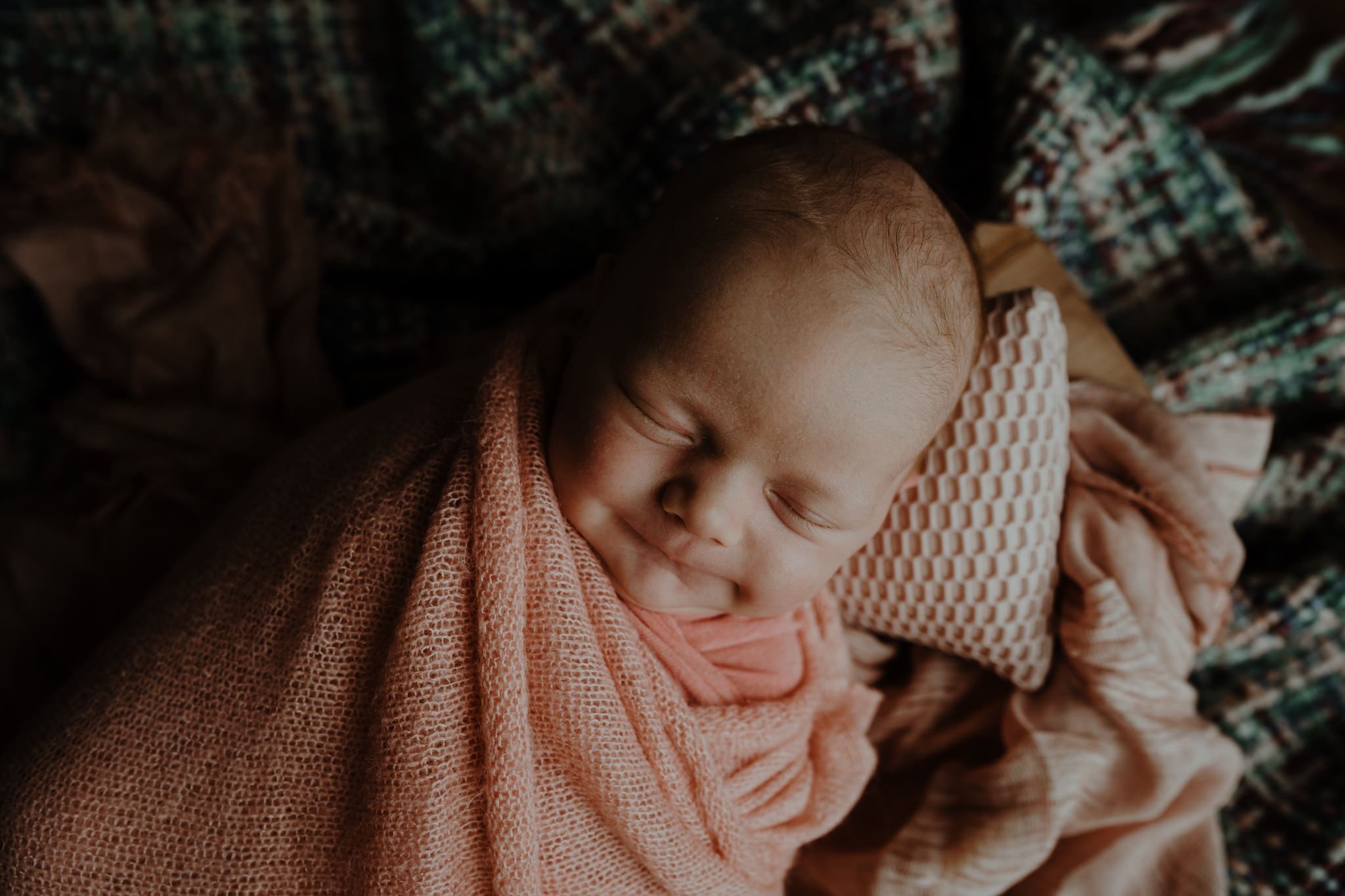 smiling sleeping newborn baby girl in home artistic newborn photographer belfast