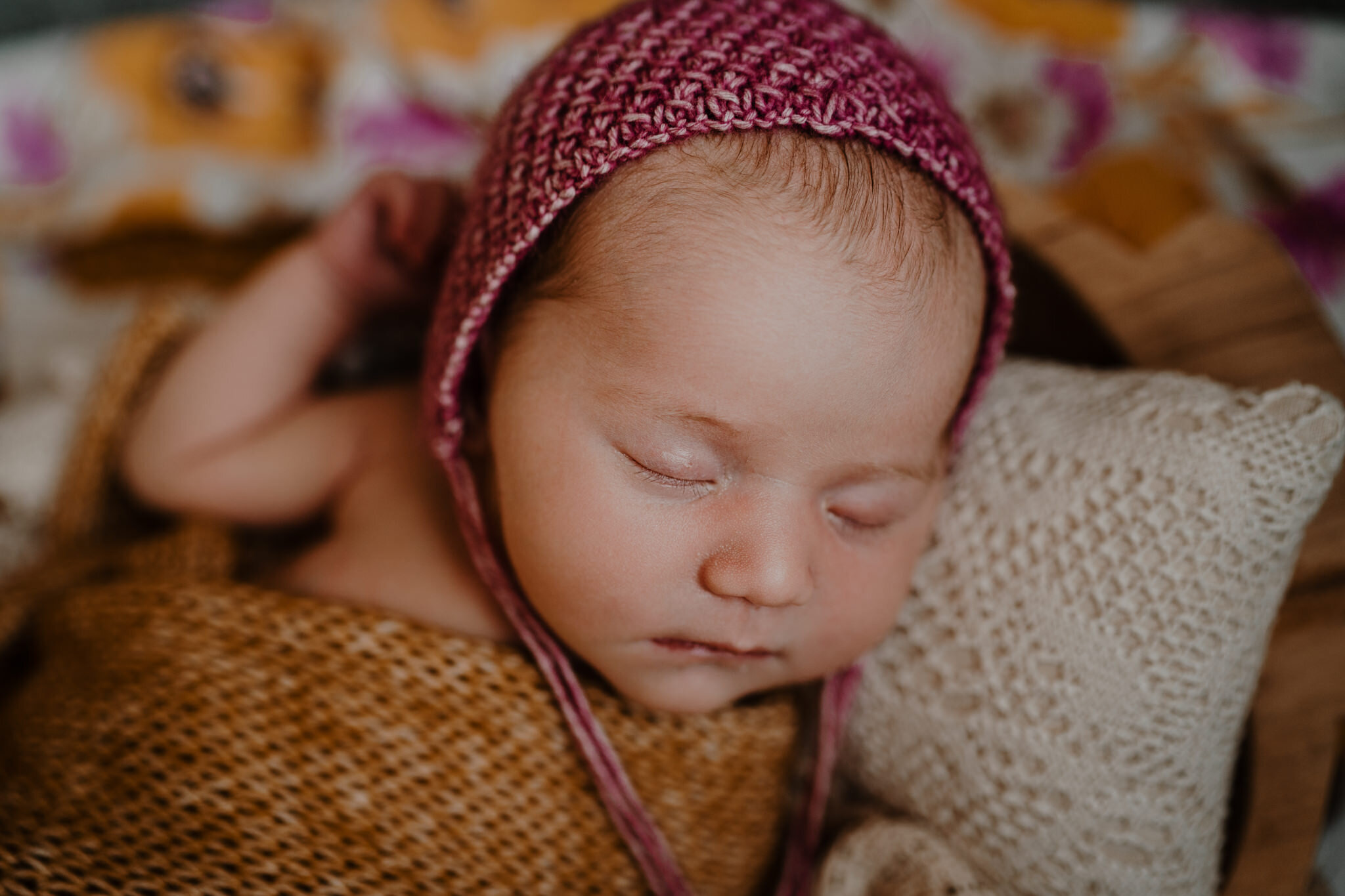 sleeping newborn baby girl raspberry bonnet mustard blanket Belfast Baby Photographers