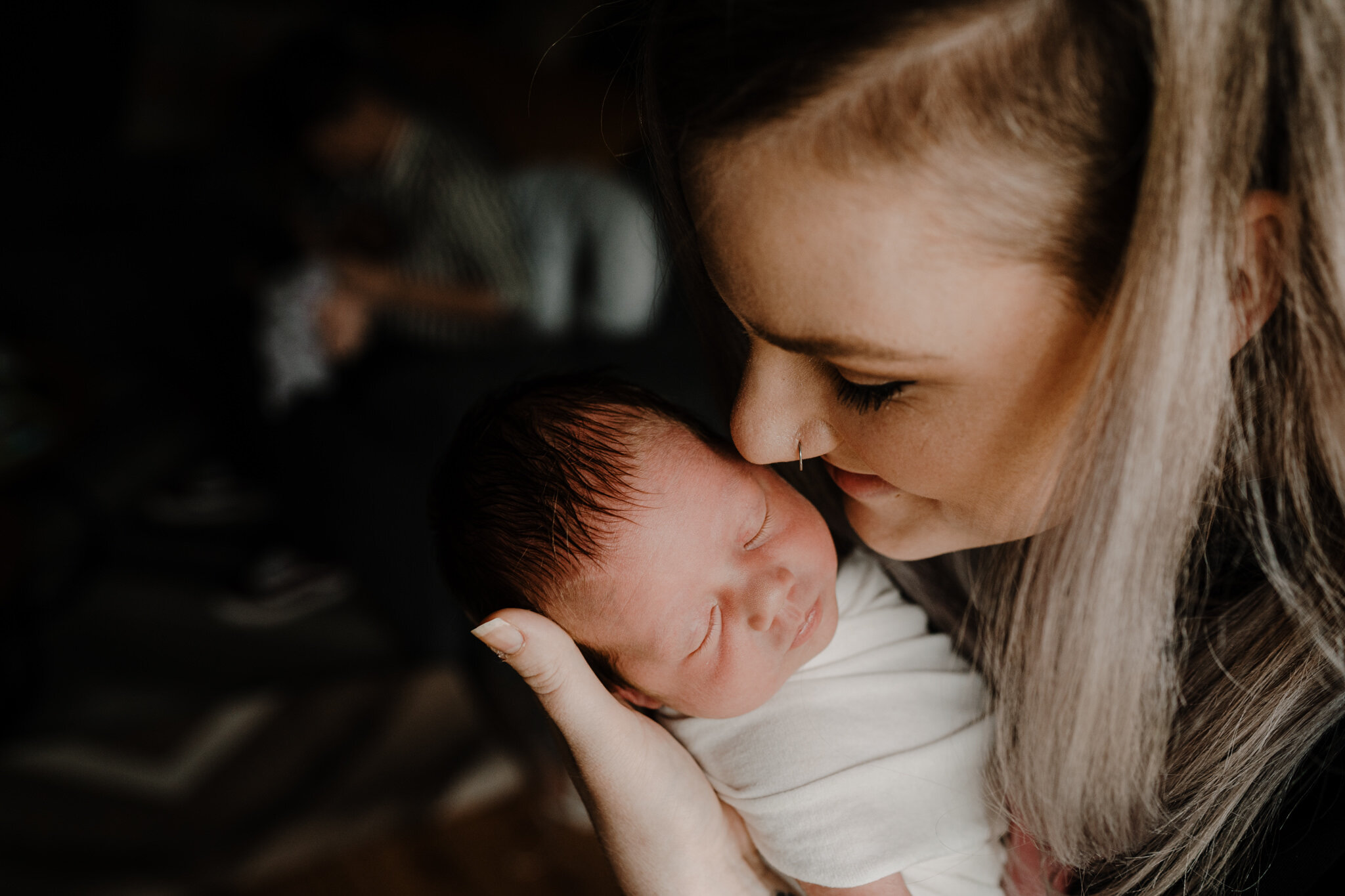 in home newborn photographer belfast mum holding baby
