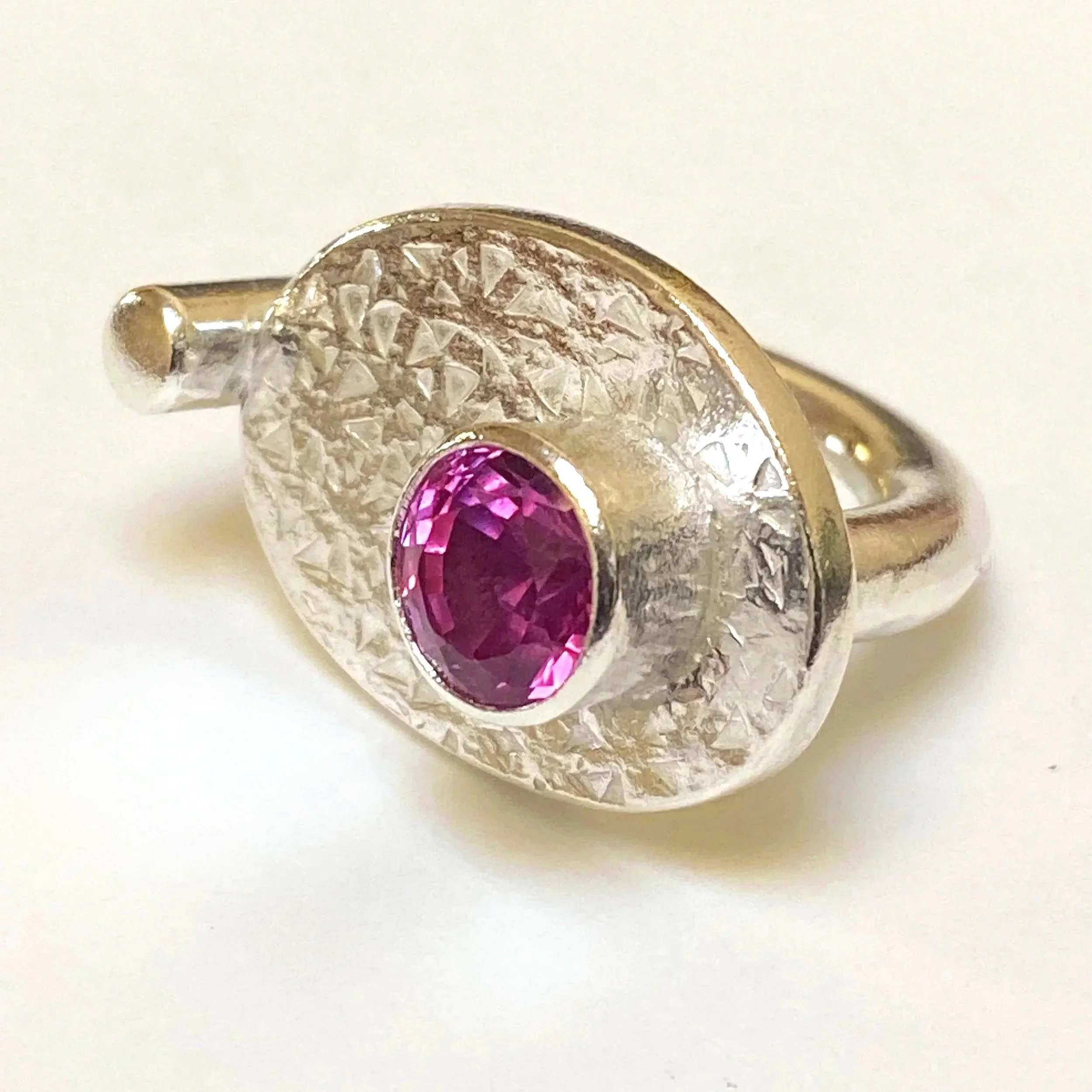 Silver and laboratory grown pink gem