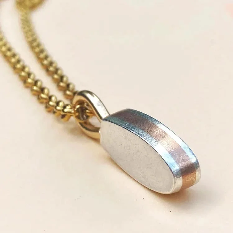 Triple-layer silver and bronze pendant