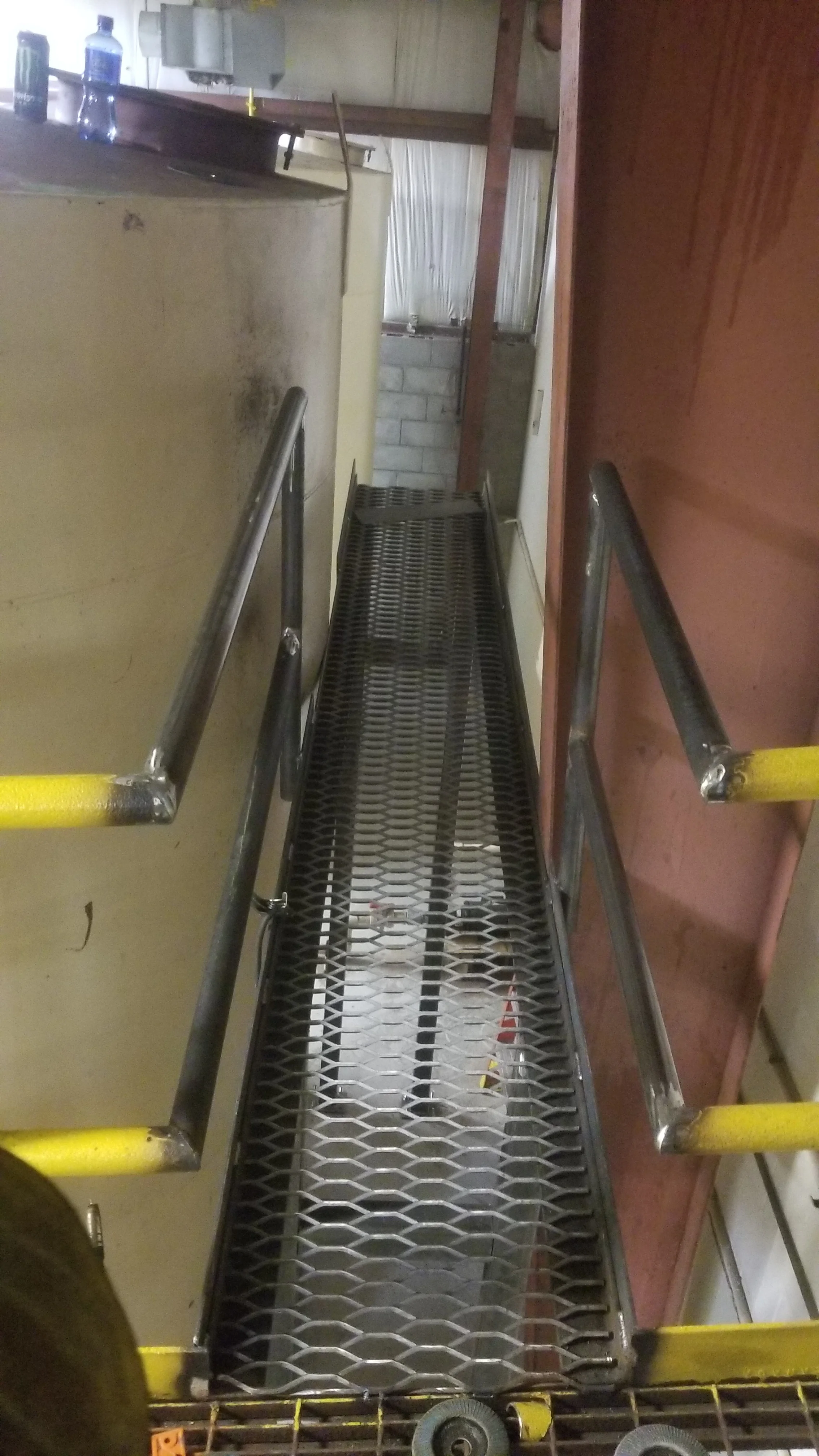 Additional walk way to tank opening to check levels. ( Not fully completed in picture) We added hand railing to the back side of catwalk.
