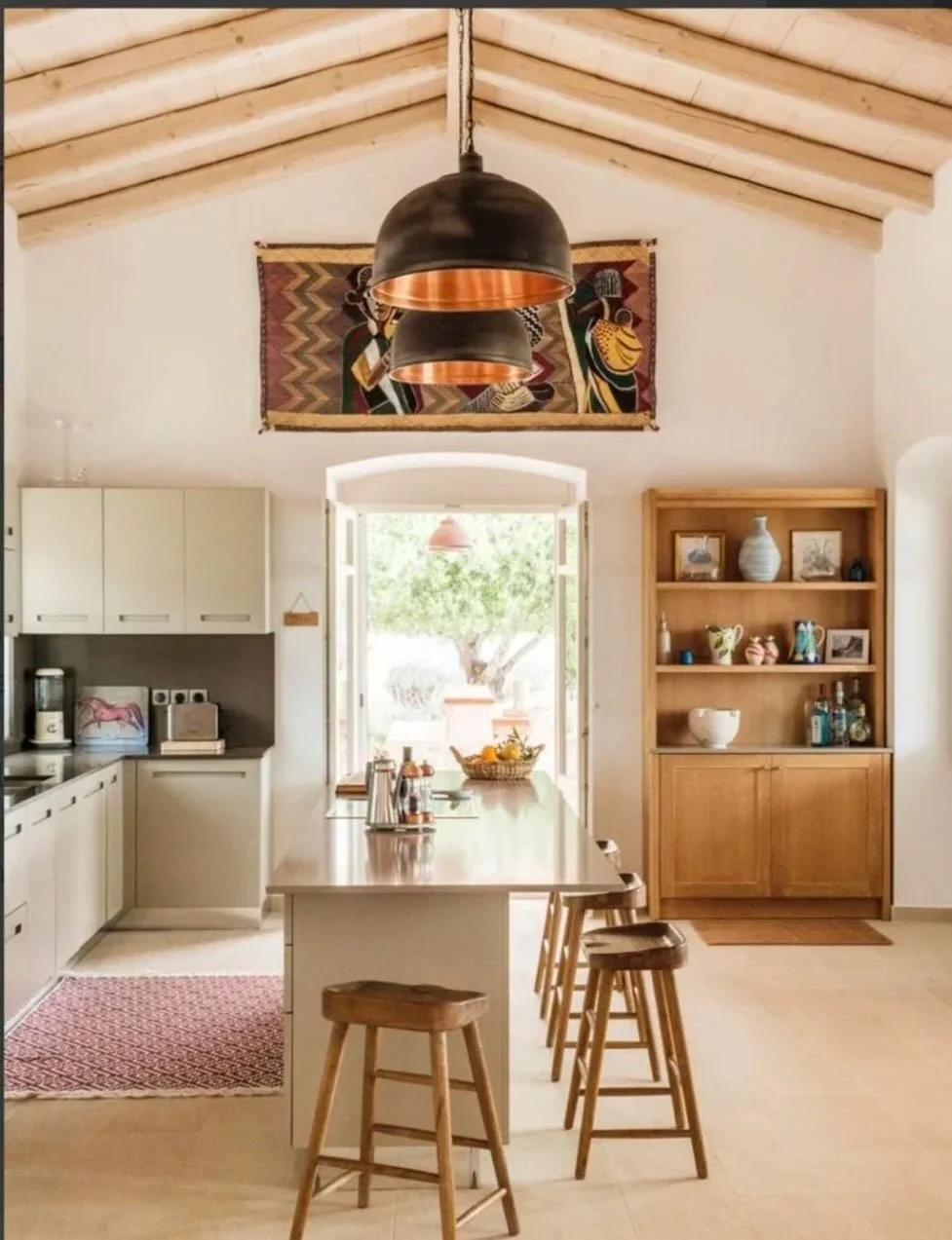 This kitchen seems so in keeping with its location - A light and airy, vaulted space - in our special Greek project. The doors open out onto an outside bar and bbq area.

I particularly love the large, raw feel to the pendants. I did worry at one poi