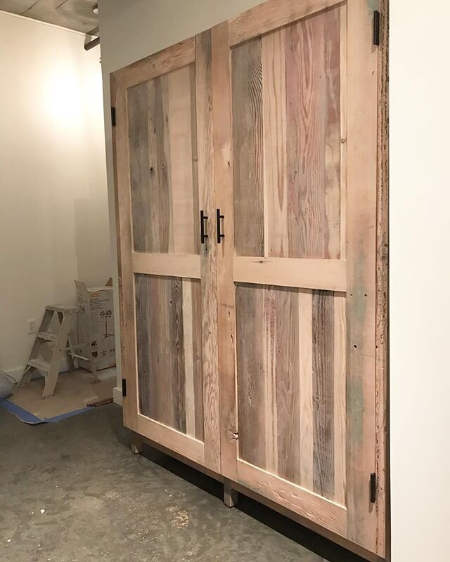 Whitewashed reclaimed wood entry closet.