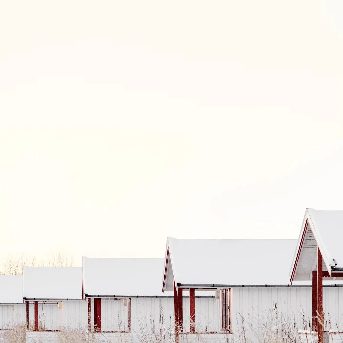 Small camping cabins on a closed-down campsite in Bod&oslash;, shelters waiting without purpose, caught between past use and an uncertain future.

From the Dictionary of Arctic Homes and Shelters project.
#contemporaryphotograpy #canonnordic #minimal