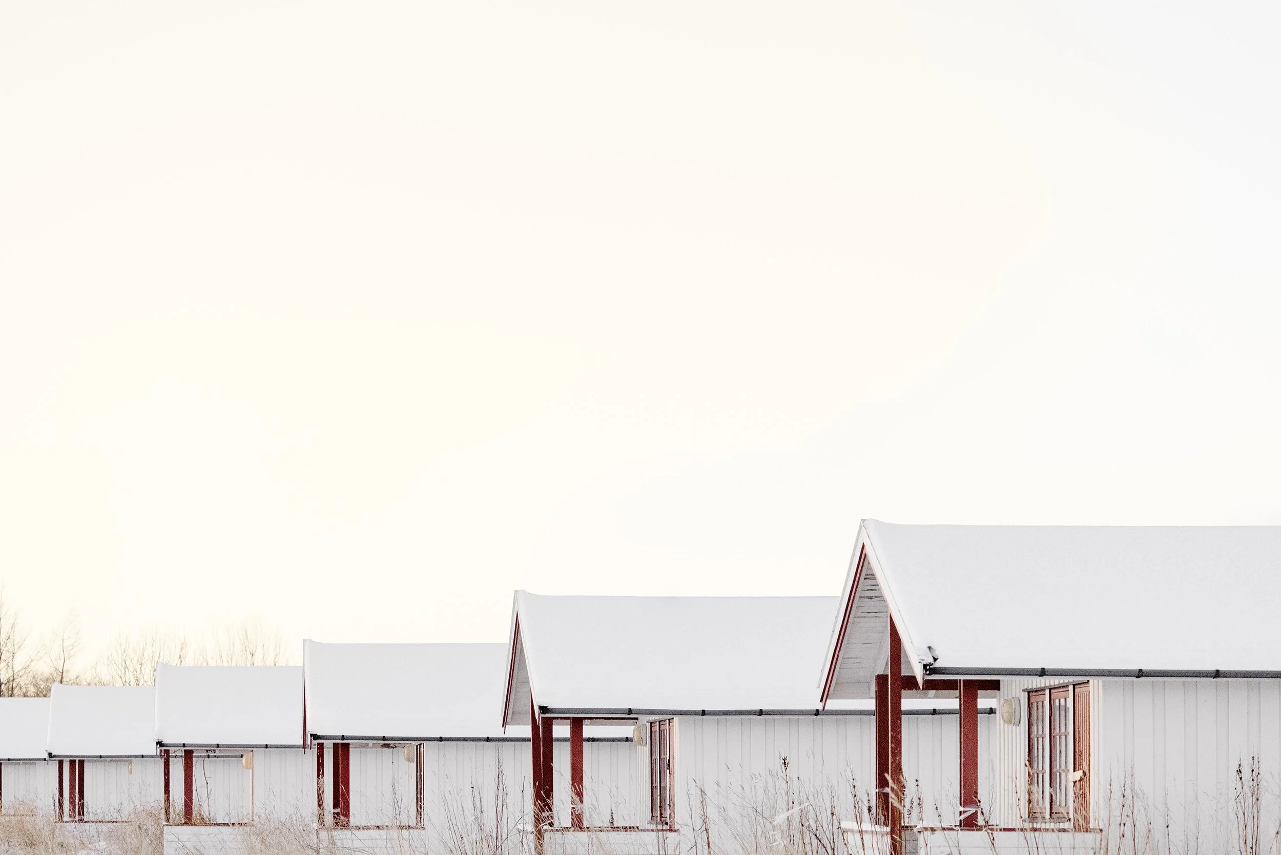 Bodø, Norway - Small camping cabins on a closed-down campsite in Bodø — shelters waiting without purpose, caught between past use and an uncertain future.