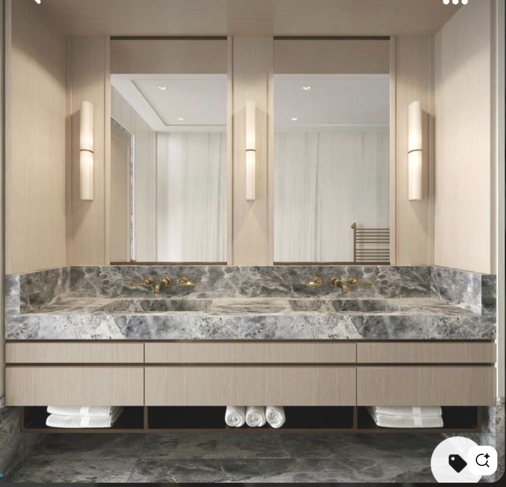 Modern bathroom vanity with double sink, marble countertop, beige cabinetry, large mirror, and wall-mounted lights.